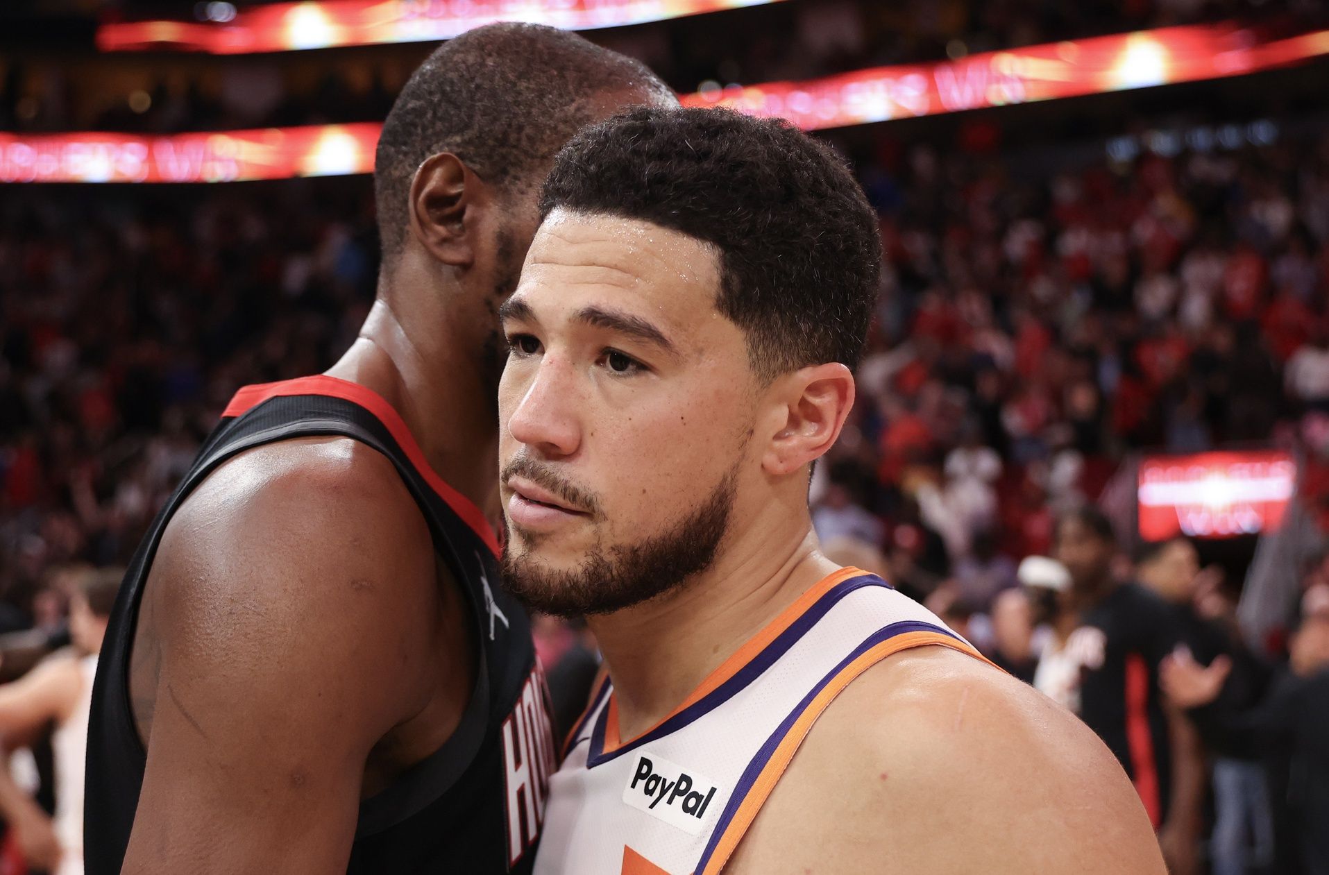 Houston Rockets forward Kevin Durant (7) hugs Phoenix Suns guard Devin Booker (1) after defeating the Phoenix Suns at Toyota Center.