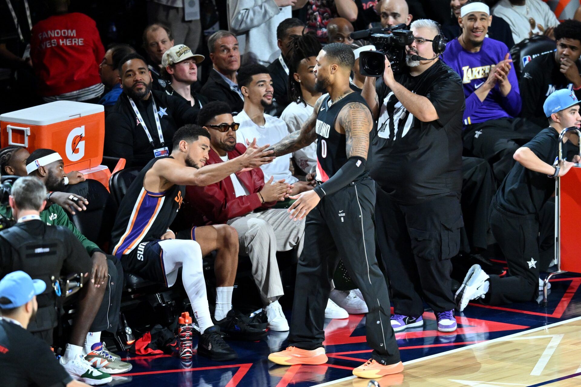 Portland Trail Blazers guard Damian Lillard (0) and Phoenix Suns guard Devin Booker (1) react in the three point contest during the 2026 NBA All Star Saturday Night at Intuit Dome.
