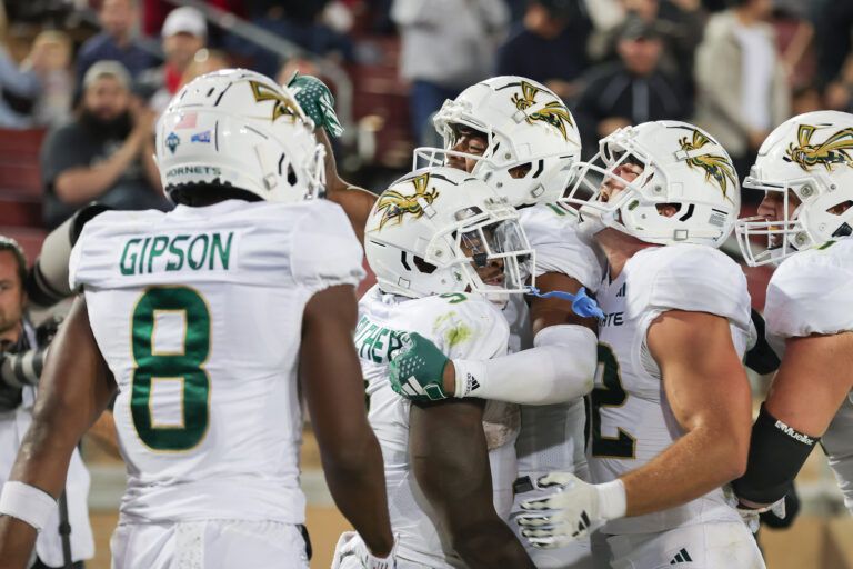 Sacramento State Hornets running back Marcus Fulcher (9) is congratulated by teammates after scoring a touchdown during the fourth quarter against the Stanford Cardinal at Stanford Stadium.