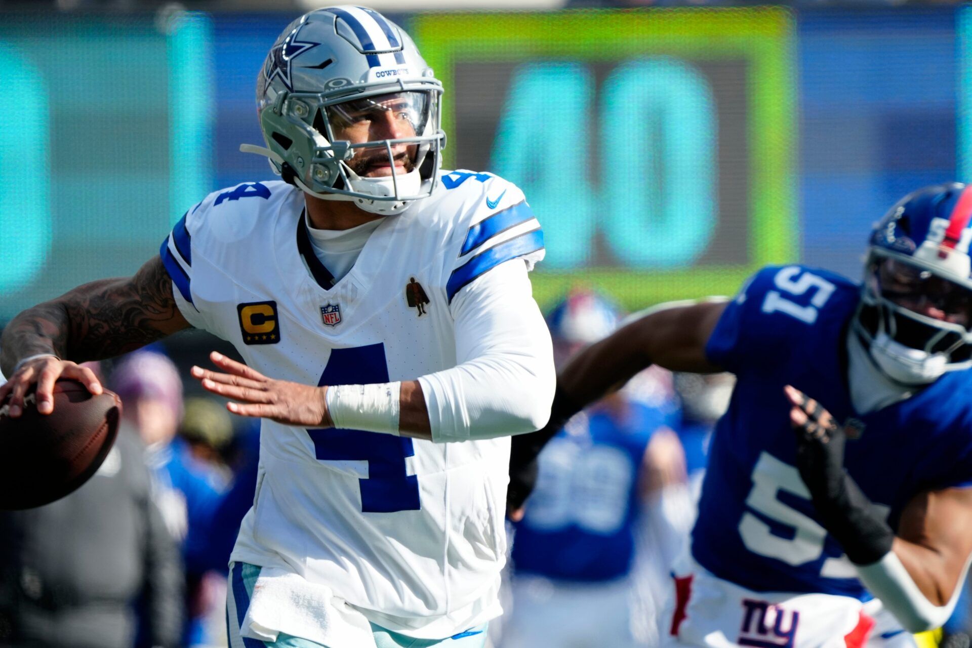 Dallas Cowboys quarterback Dak Prescott (4) looks for an open receiver as New York Giants linebacker Abdul Carter (51) runs towards him, Sunday, January 4, 2026, in East Rutherford.