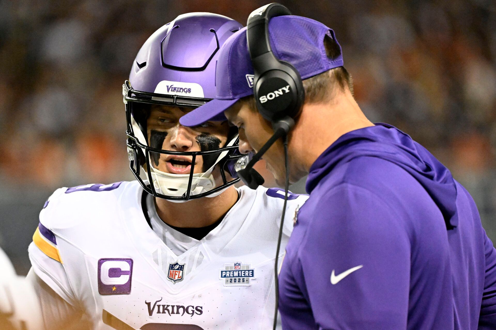 Minnesota Vikings head coach Kevin O'Connell talks with quarterback J.J. McCarthy (9) during the first half at Soldier Field.