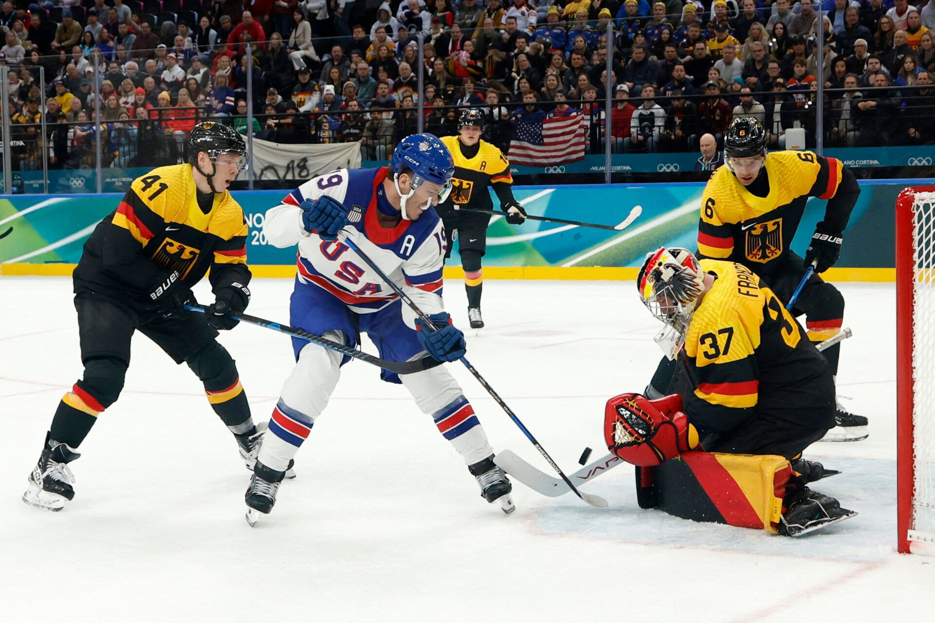 Matthew Tkachuk of United States in action with Maximilian Franzreb of Germany in men's ice hockey group C play during the Milano Cortina 2026 Olympic Winter Games at Milano Santagiulia Ice Hockey Arena.