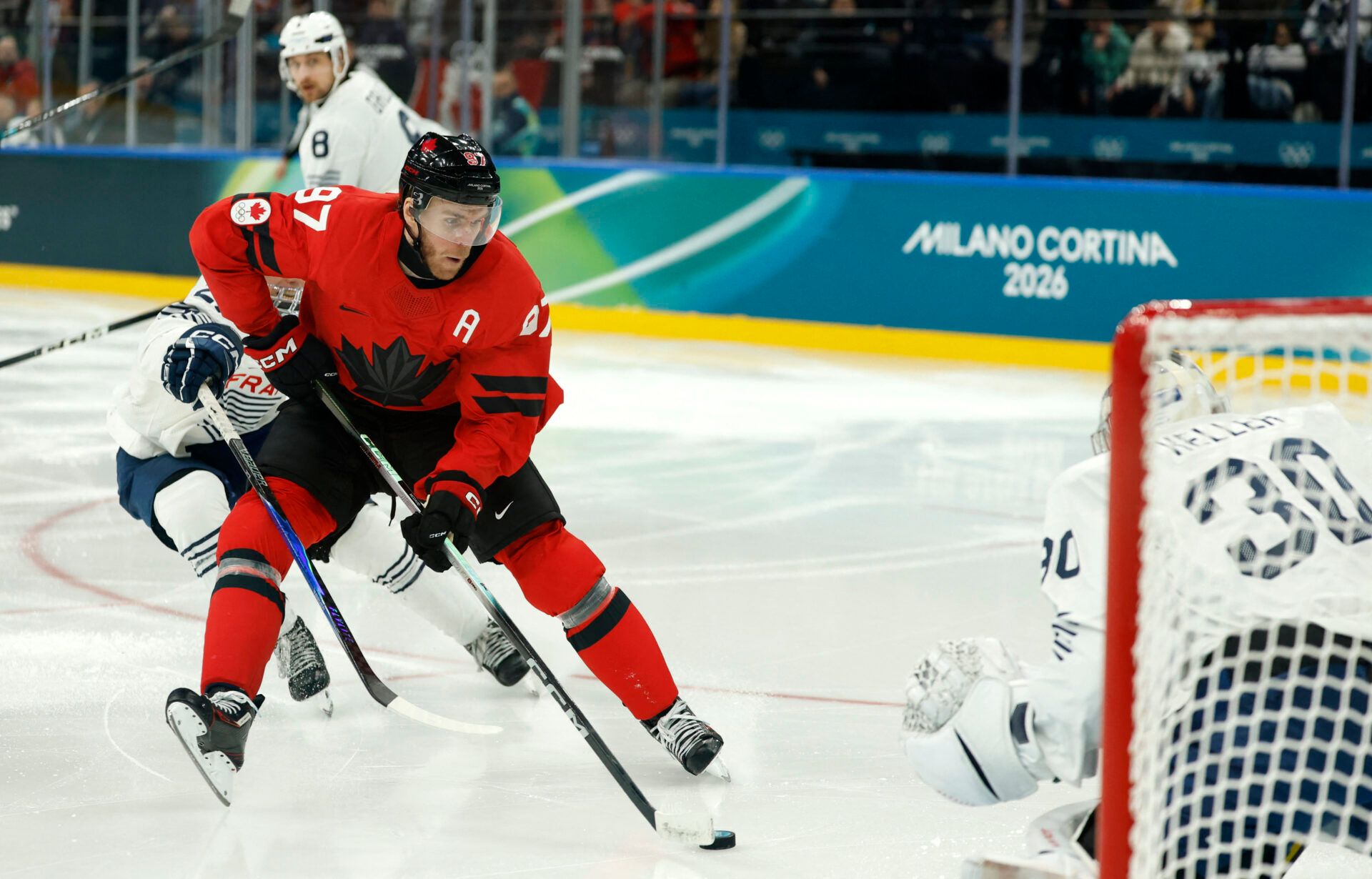 Connor McDavid of Canada scores their seventh goal against France in men's ice hockey group A play during the Milano Cortina 2026 Olympic Winter Games at Milano Santagiulia Ice Hockey Arena.