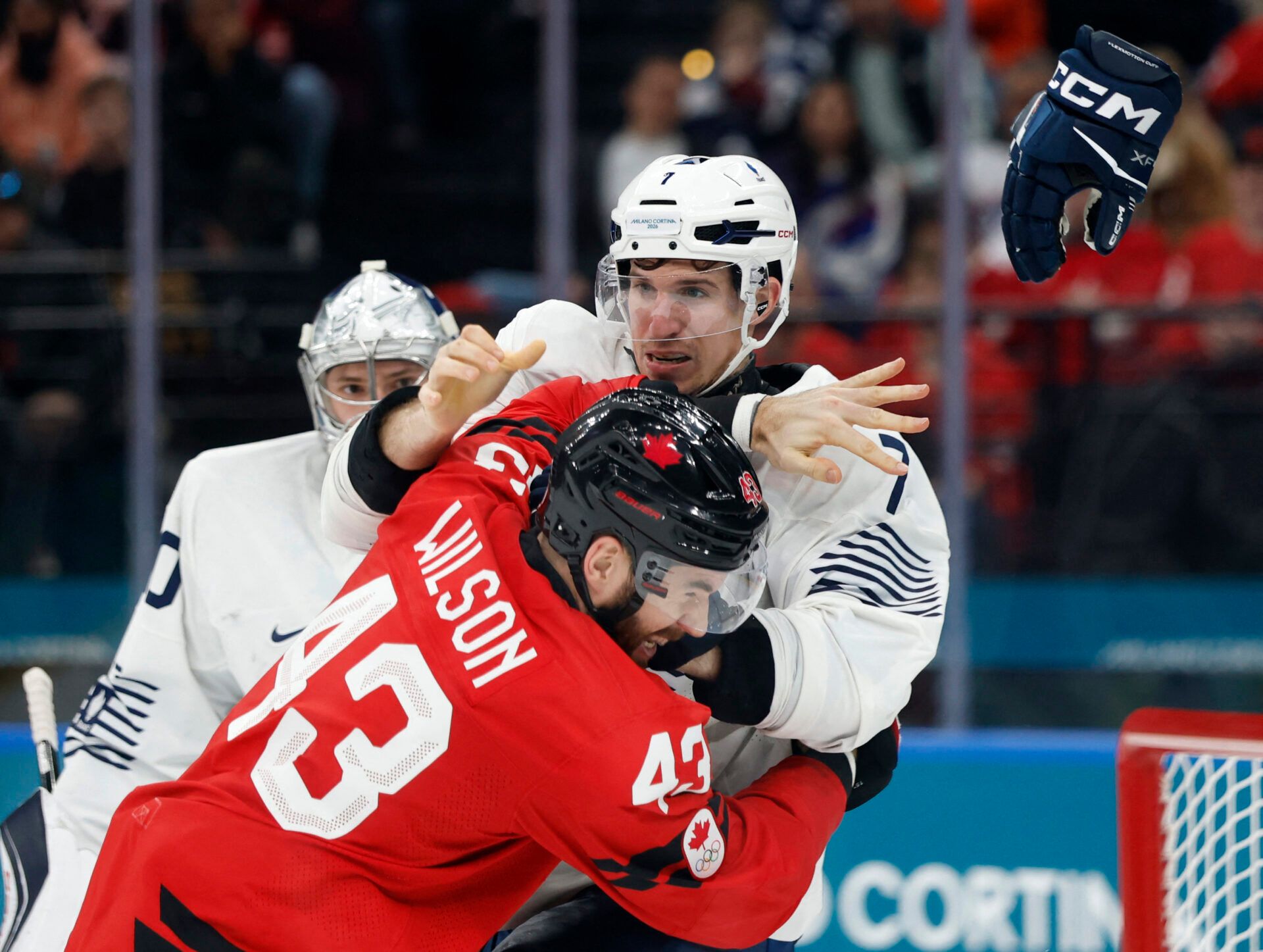 Tom Wilson of Canada clashes with Pierre Crinon of France in men's ice hockey group A play during the Milano Cortina 2026 Olympic Winter Games at Milano Santagiulia Ice Hockey Arena.