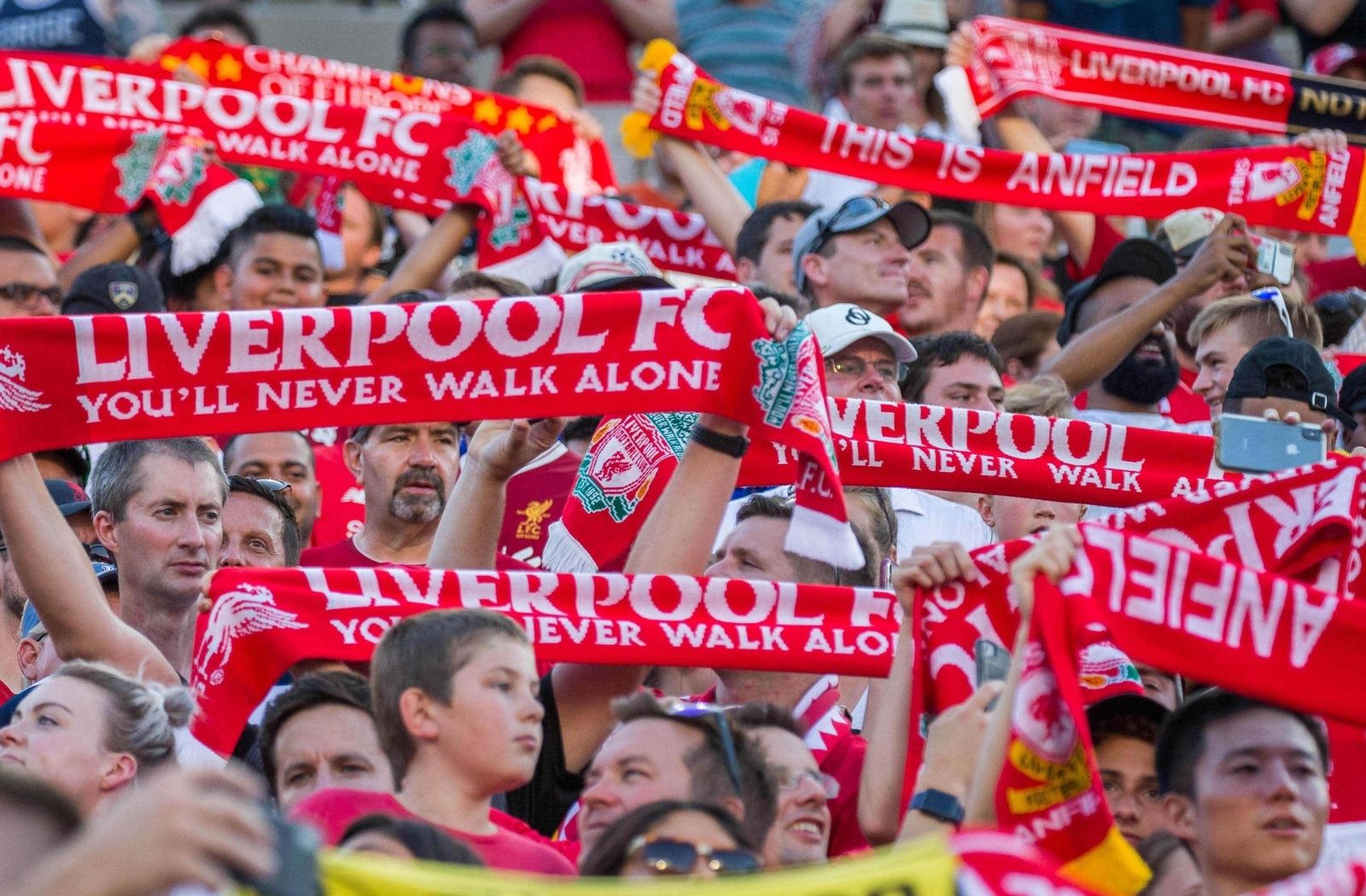 Liverpool fans hold up their scarves and sing you will never walk alone before the start of a pre-season preparation soccer match between the Liverpool and the Borussia Dortmund at Notre Dame.