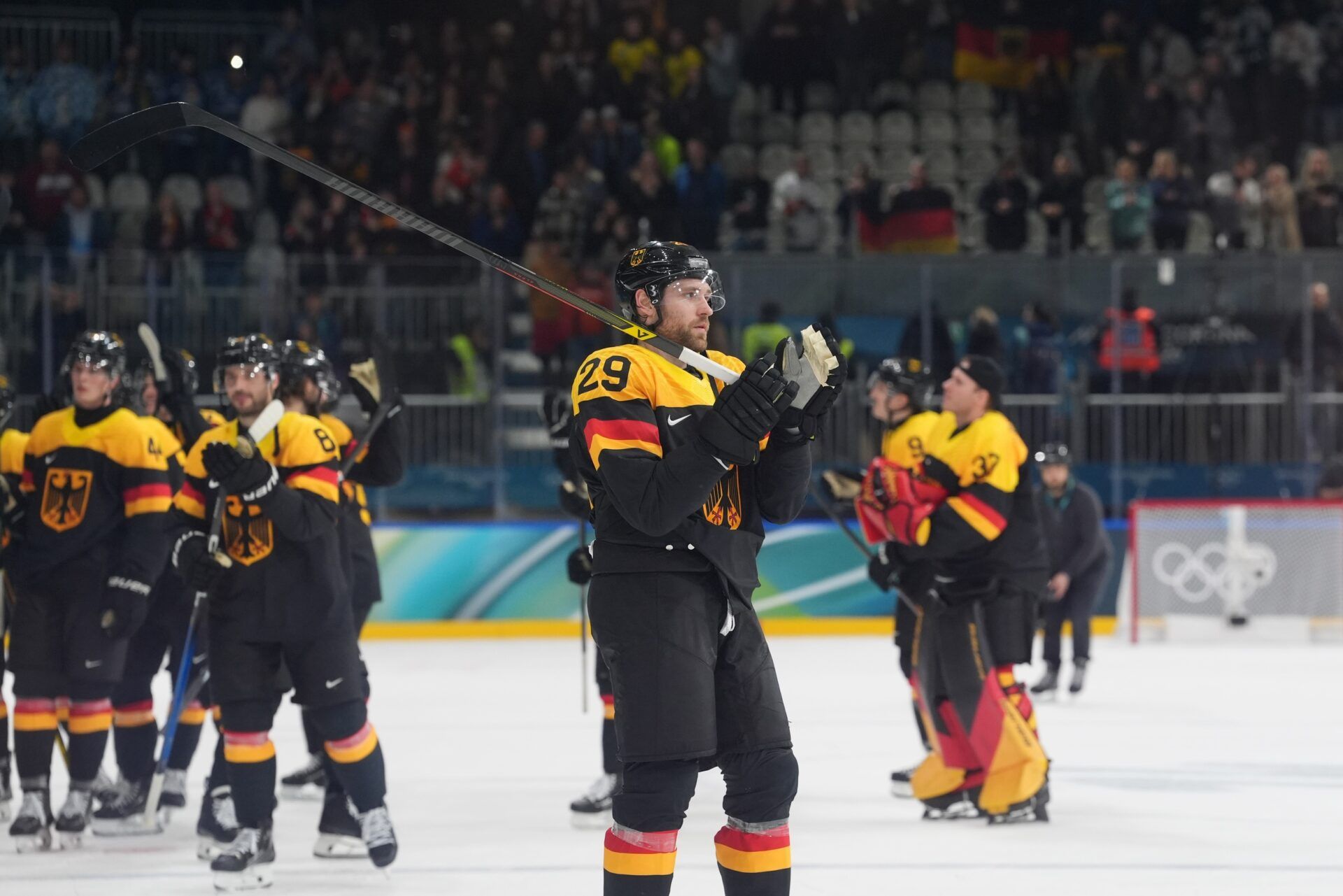 Leon Draisaitl of Germany celebrates after defeating Denmark in men's ice hockey Group C play during the Milano Cortina 2026 Olympic Winter Games at Milano Rho Ice Hockey Arena.