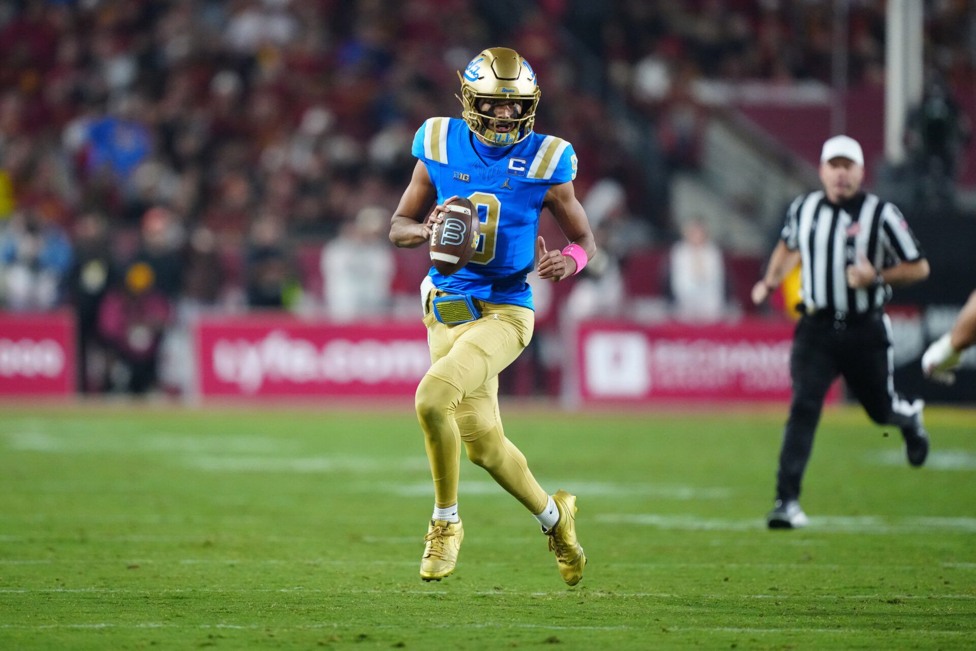 UCLA Bruins quarterback Nico Iamaleava (9) carries the ball against the Southern California Trojans in the first half at United Airlines Field at Los Angeles Memorial Coliseum.