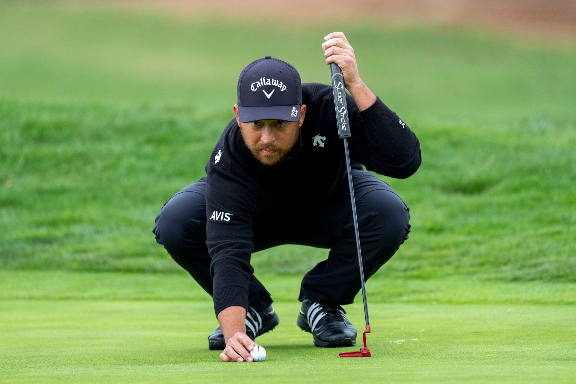 Xander Schauffele lines up his putt on the second hole during the final round of the AT&T Pebble Beach Pro-Am golf tournament at Pebble Beach Golf Links.