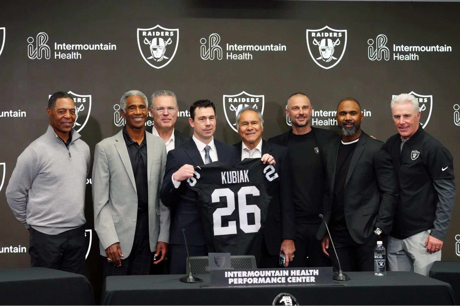 Las Vegas Raiders coach Klint Kubiak (center) poses at introductory press conference at Intermountain Health Performance Center. From left: Marcus Allen, Mike Haynes, Howie Long, Kubiak, general manager John Spyktek, Charles Woodson and Rich Gannon.
