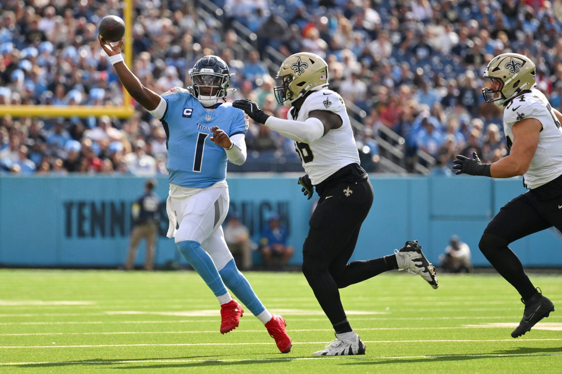Tennessee Titans quarterback Cam Ward (1) throws a pass against New Orleans Saints defensive end Carl Granderson (96) during the first quarter of the game at Nissan Stadium.