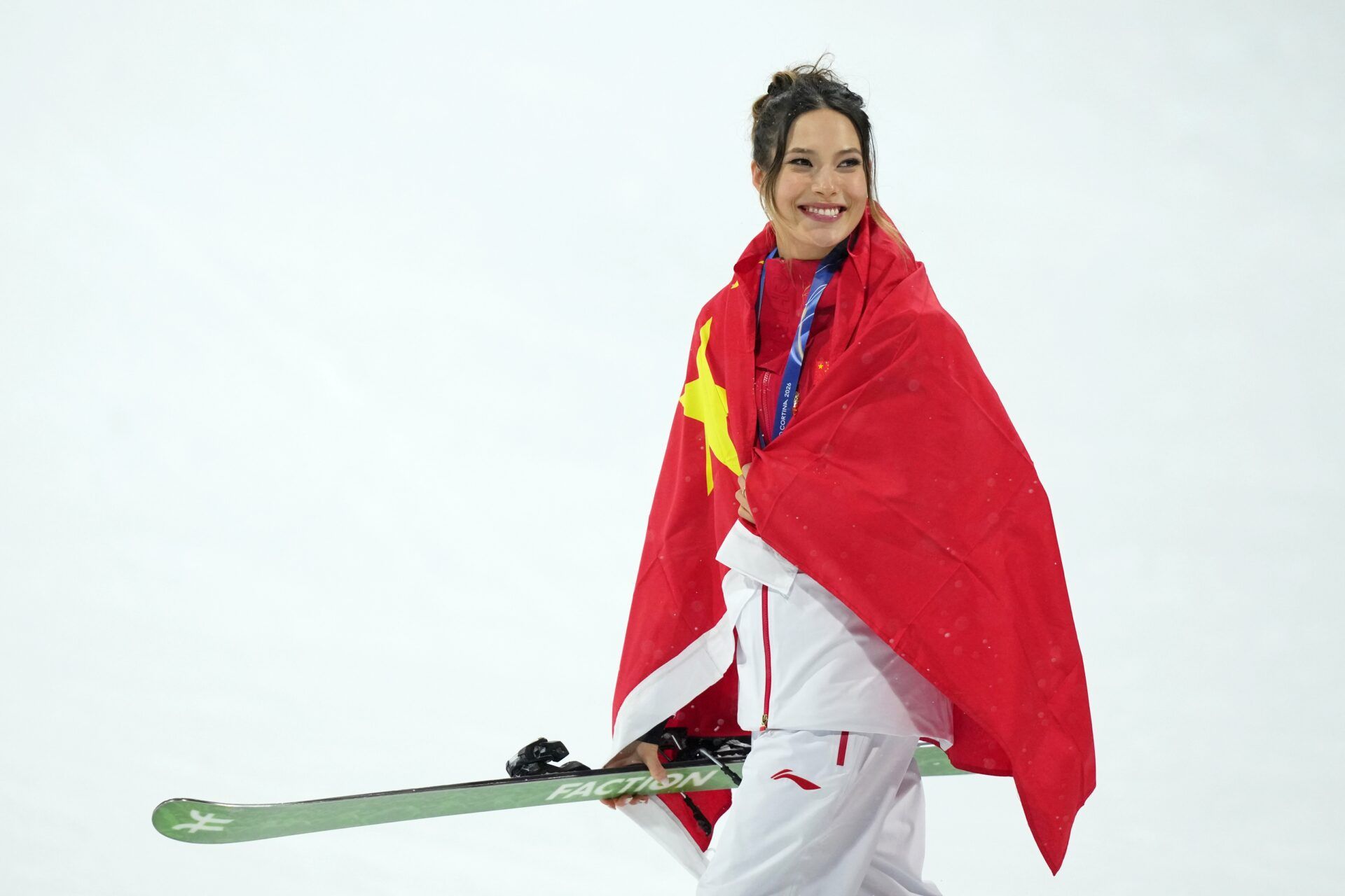 Silver medalist Ailing Eileen Gu of the People's Republic of China celebrates during the medal ceremony for the women's big air final during the Milano Cortina 2026 Olympic Winter Games at Livigno Snow Park.