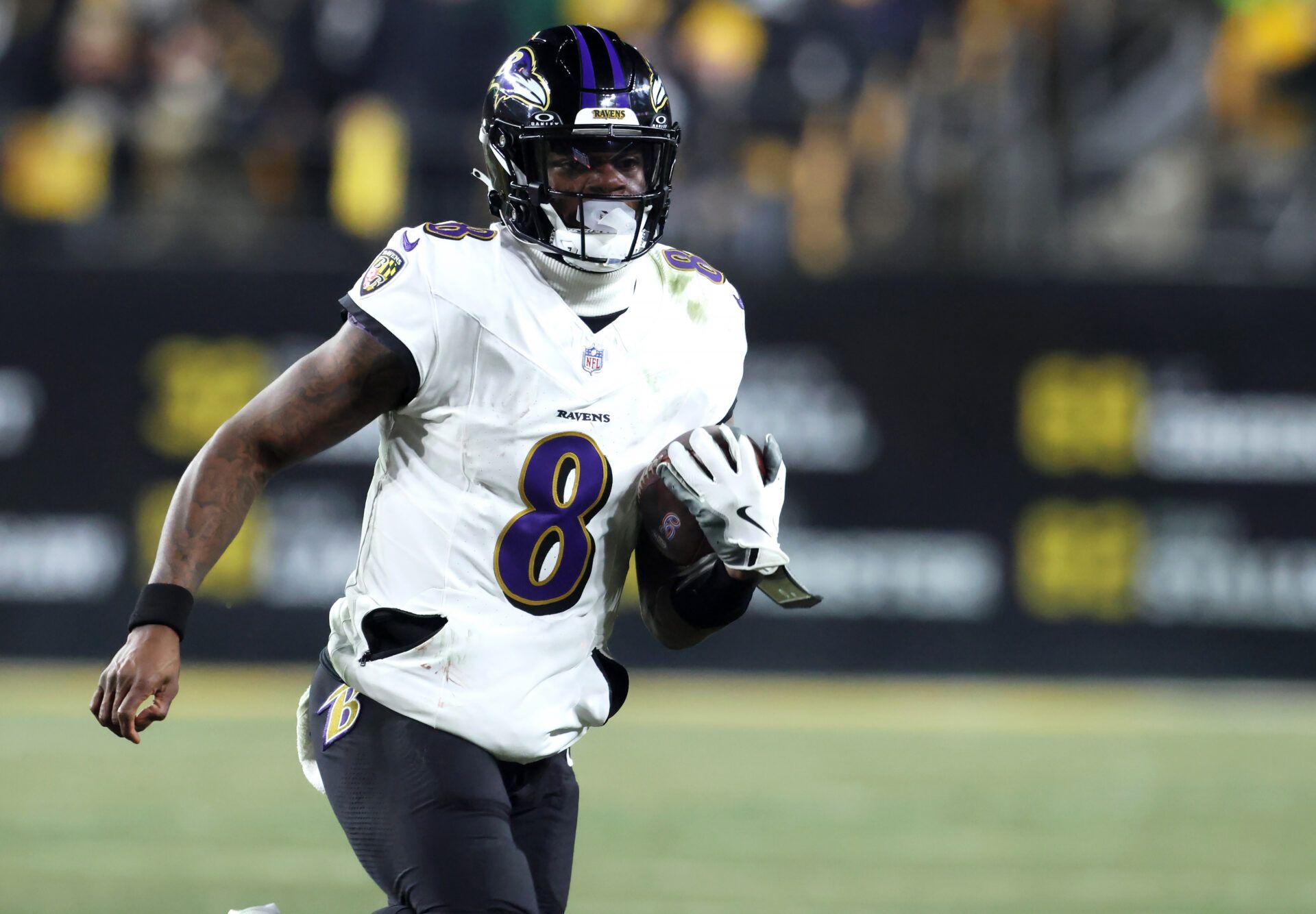 Baltimore Ravens quarterback Lamar Jackson (8) rushes the ball against the Pittsburgh Steelers during the first half at Acrisure Stadium.