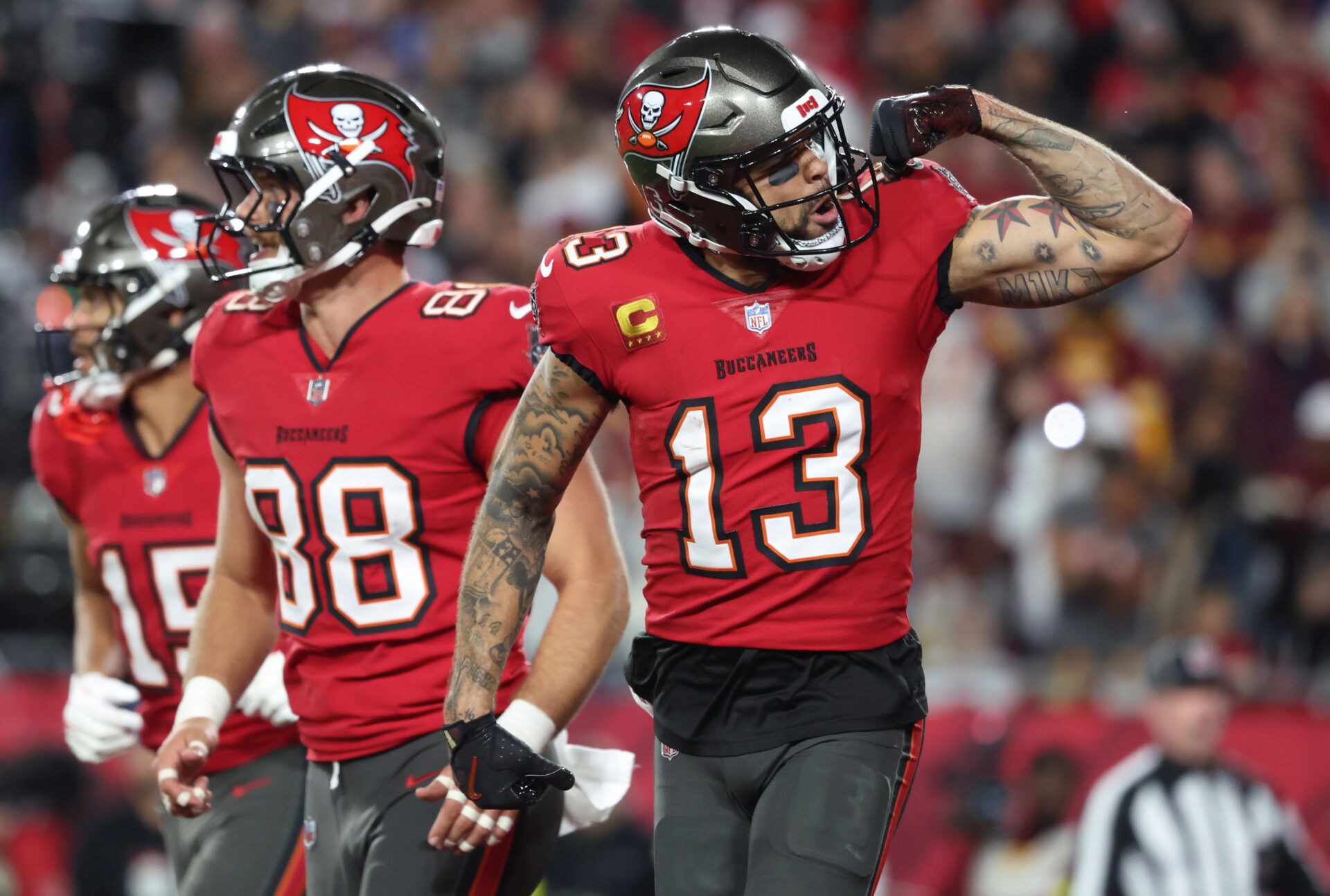 Tampa Bay Buccaneers wide receiver Mike Evans (13) celebrates after a touchdown catch with tight end Cade Otton (88) during the second quarter of a NFC wild card playoff against the Washington Commanders at Raymond James Stadium.