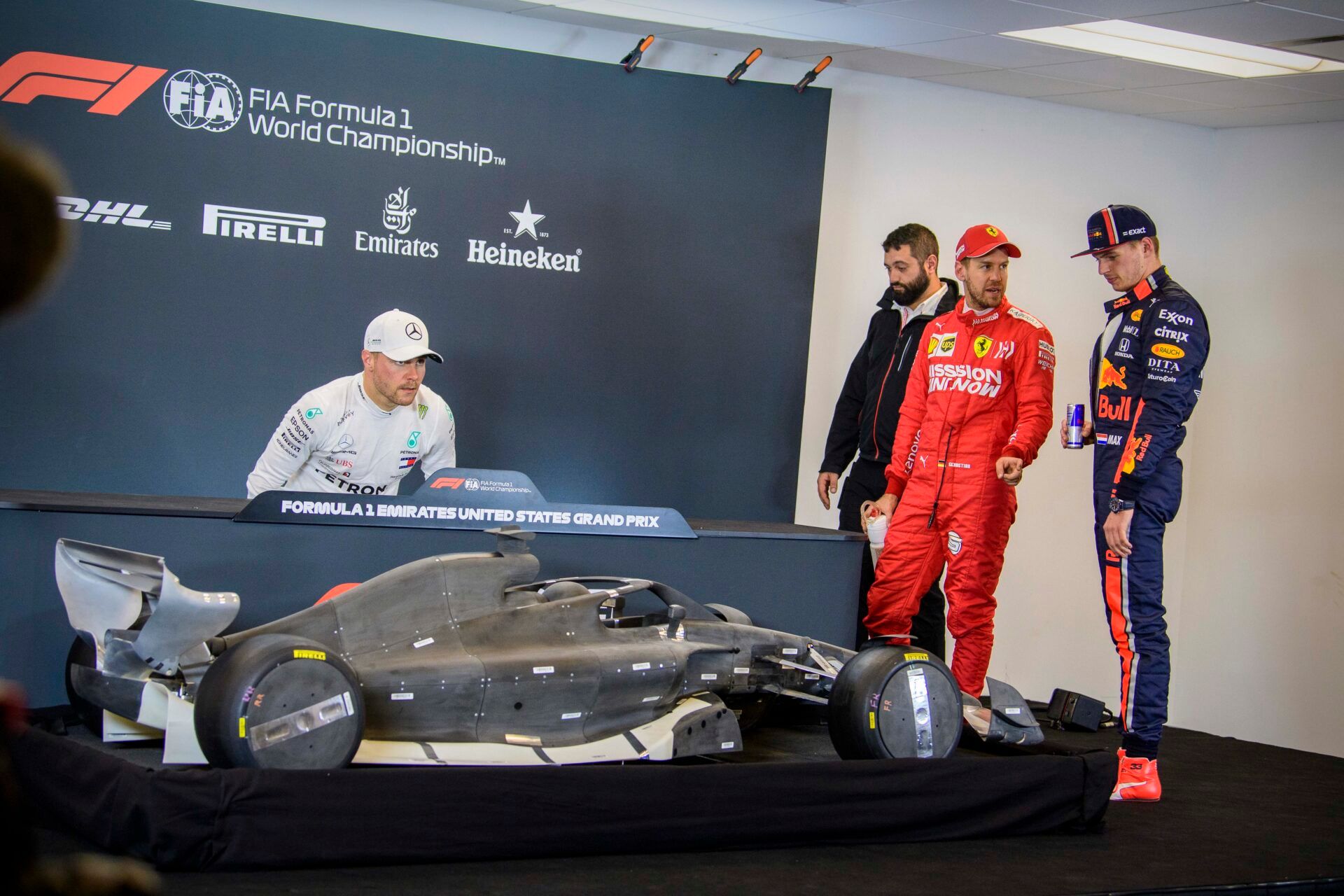 (from left) Mercedes AMG Petronas Motorsport driver Valtteri Bottas (77) of Finland and Scuderia Ferrari Mission Winnow driver Sebastian Vettel (5) of Germany and Aston Martin Red Bull Racing Honda driver Max Verstappen (33) of Netherlands check out the mockup model of the 2021 F1 car after qualifying for the United States Grand Prix at Circuit of the Americas.