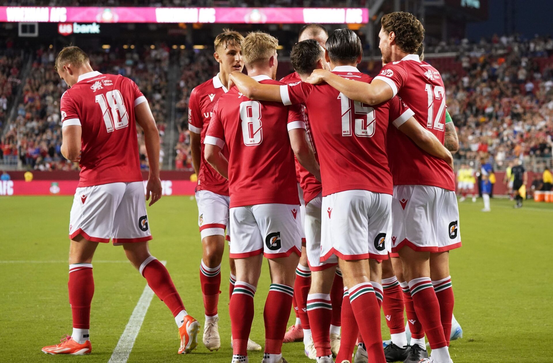 Wrexham defender Lewis Brunt (3), Wrexham forward Sam Dalby (18), Wrexham midfielder Andy Cannon (8), Wrexham midfielder George Dobson (15), and Wrexham midfielder George Evans (12) celebrate after a goal against Chelsea in the second half at Levi's Stadium.