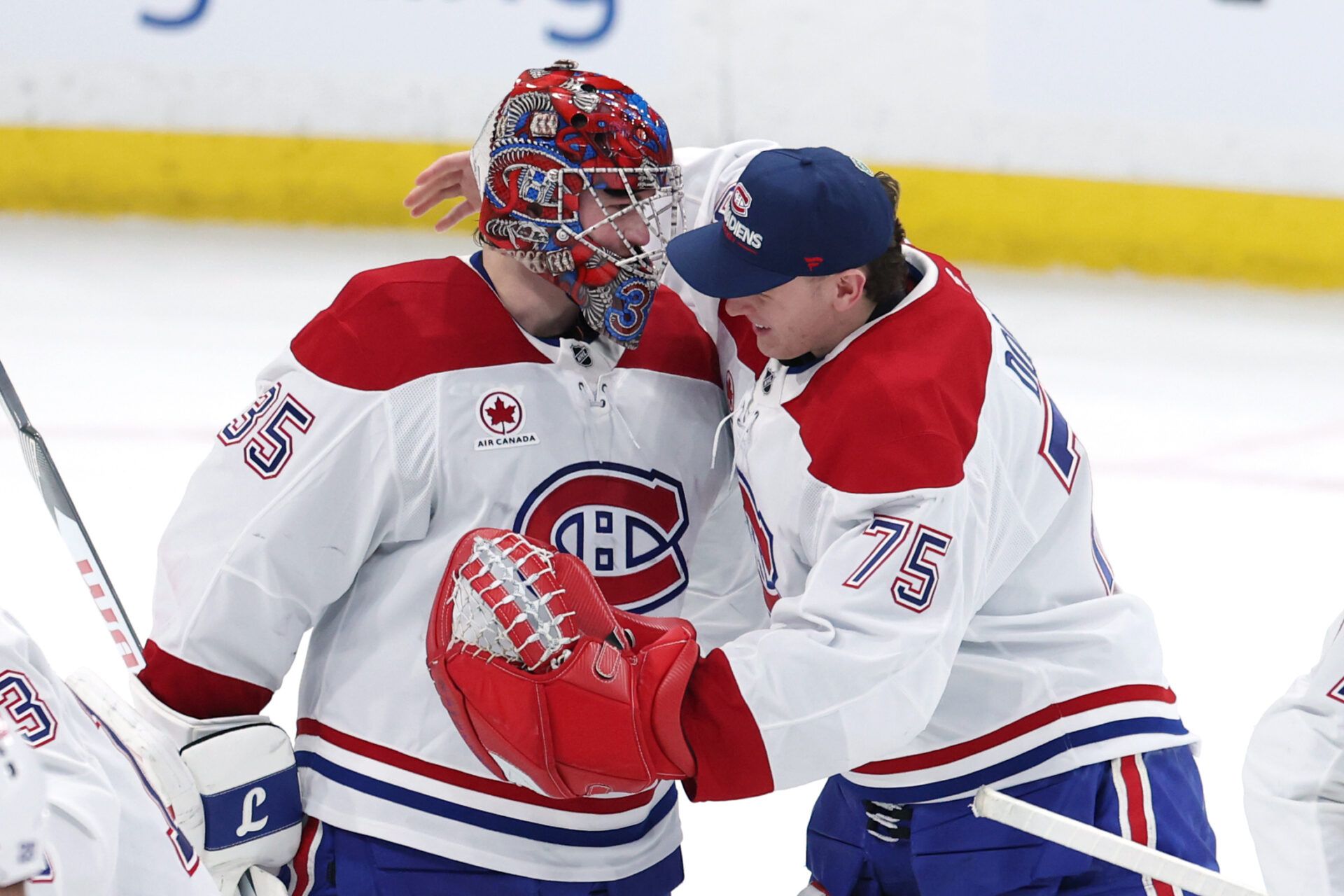 Montreal Canadiens goaltender Samuel Montembeault (35) and goaltender Jakub Dobes (75) celebrate a victory against the Winnipeg Jets at Canada Life Centre.