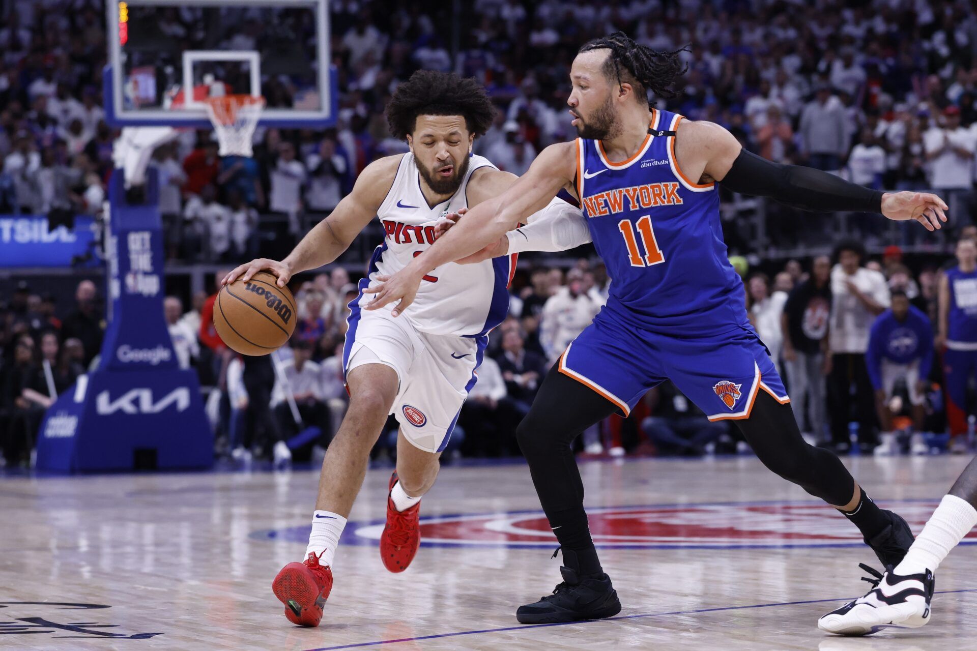 Detroit Pistons guard Cade Cunningham (2) dribbles defended by New York Knicks guard Jalen Brunson (11) in the second half during game six of first round for the 2024 NBA Playoffs at Little Caesars Arena.