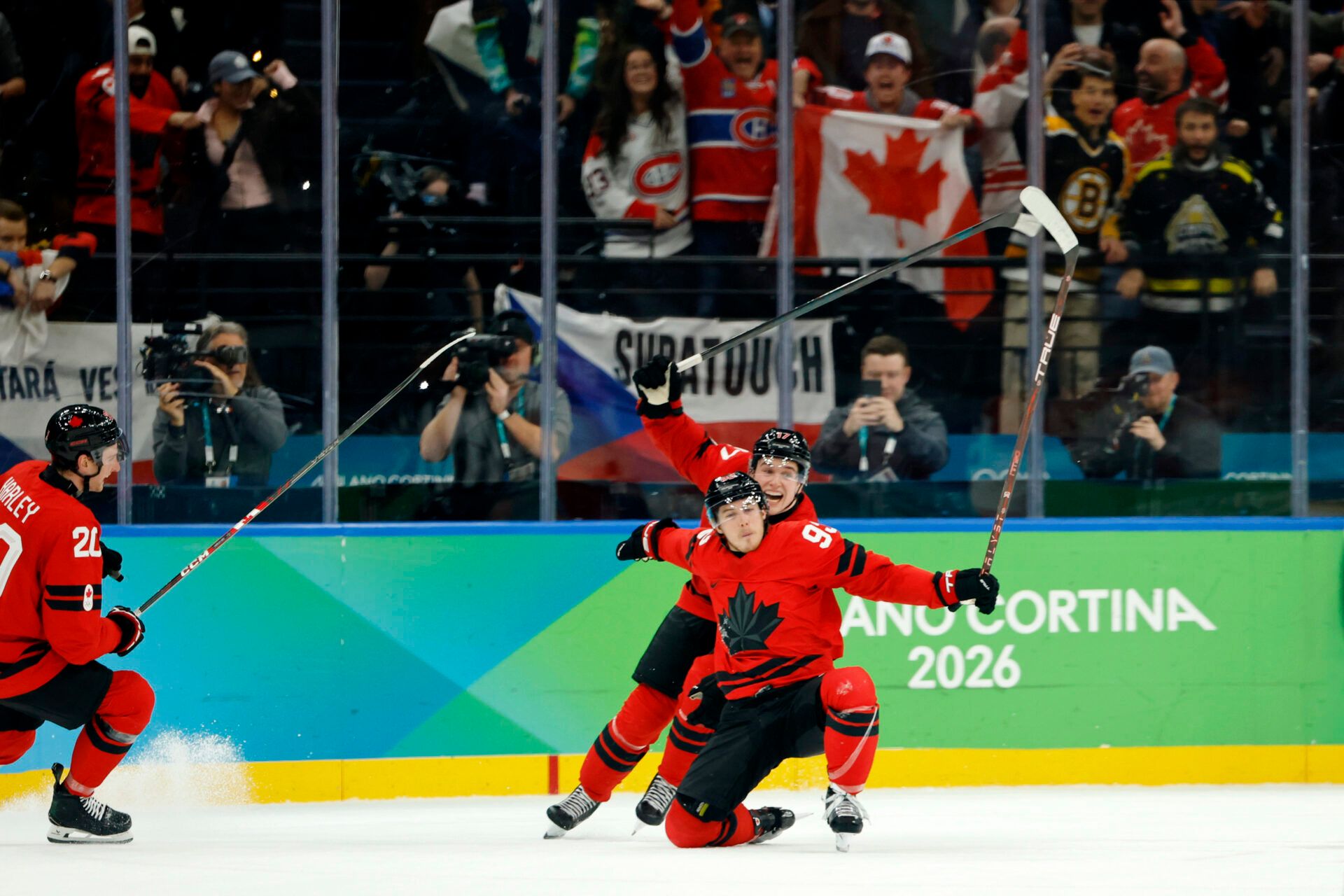 Mitch Marner of Canada celebrates with Thomas Harley after scoring their fourth and game-winning goal against Czechia in a men's ice hockey quarterfinal during the Milano Cortina 2026 Olympic Winter Games at Milano Santagiulia Ice Hockey Arena.
