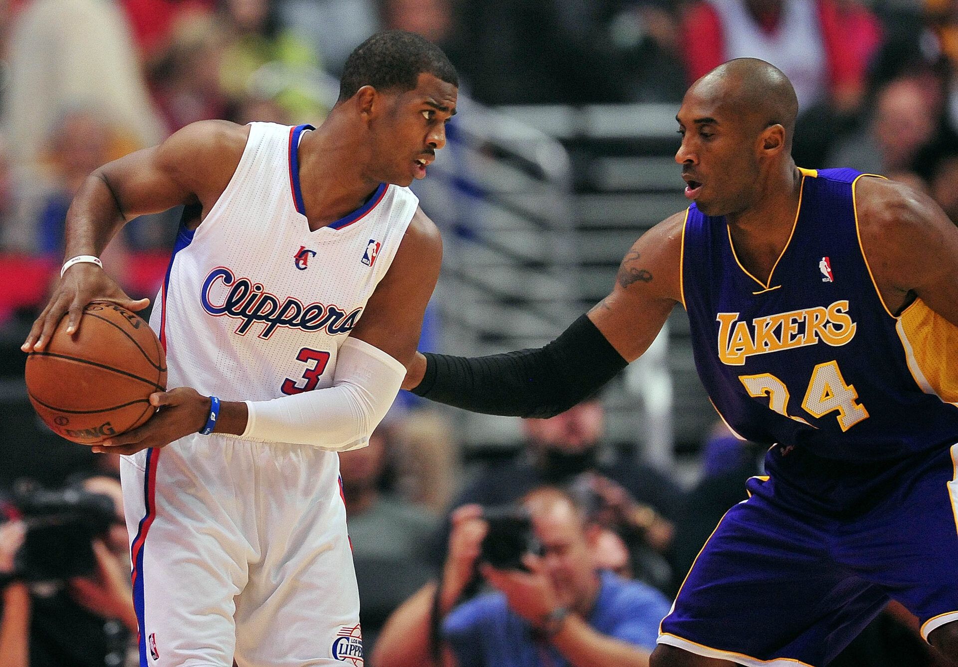 Los Angeles Clippers point guard Chris Paul (3) controls the ball against the defense of Los Angeles Lakers shooting guard Kobe Bryant (24) during the first half at Staples Center.