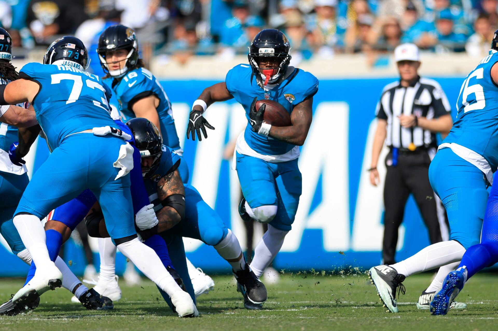 Jacksonville Jaguars running back Travis Etienne Jr. (1) rushes for yards during the first quarter of an NFL football AFC Wild Card playoff matchup, Sunday, Jan. 11, 2026, in Jacksonville, Fla. The Bills defeated the Jaguars 27-24. [Corey Perrine/Florida Times-Union]