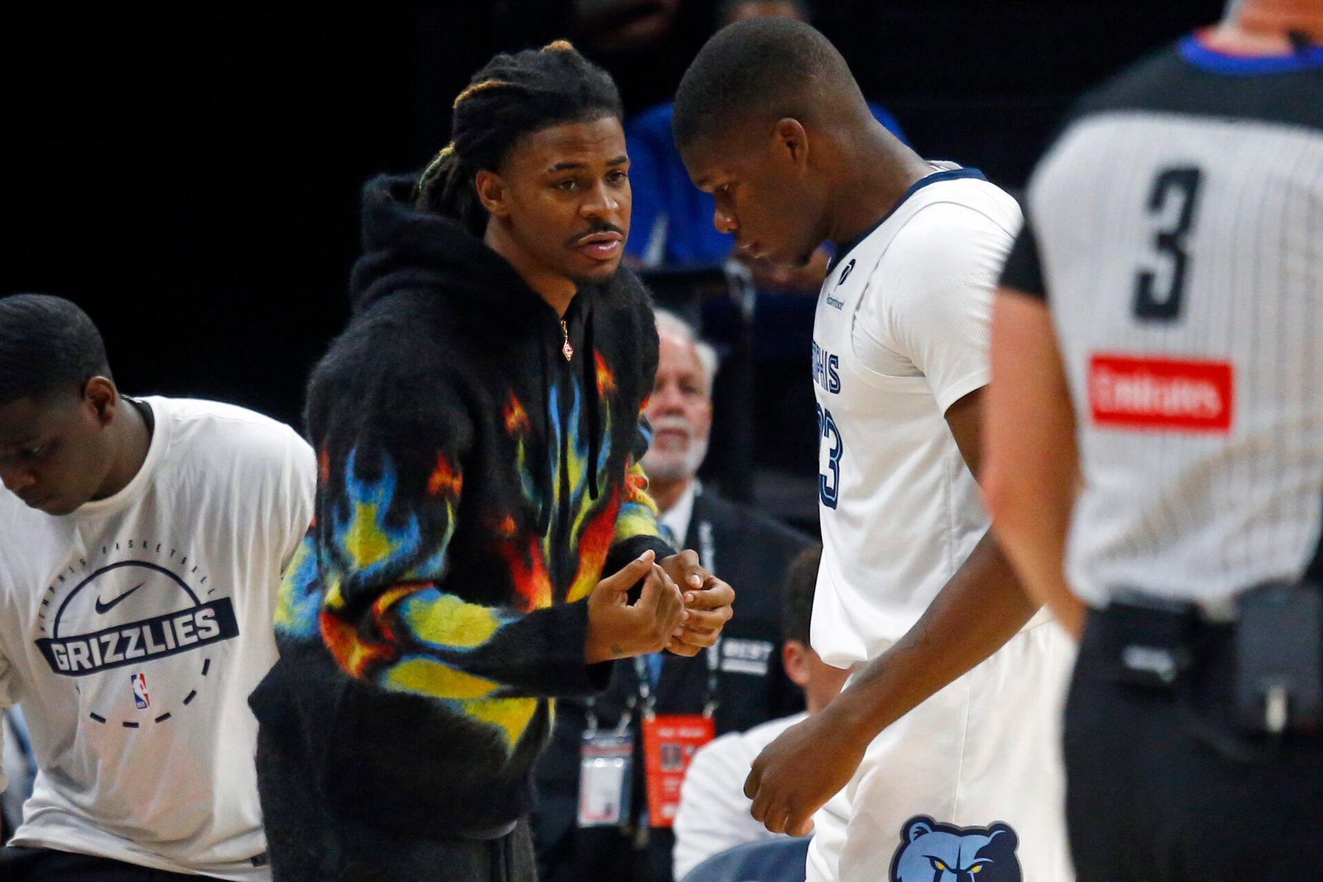 Memphis Grizzlies guard Ja Morant (12) talks with Memphis Grizzlies forward Cedric Coward (23) during a time out during the second quarter against the Detroit Pistons at FedExForum.