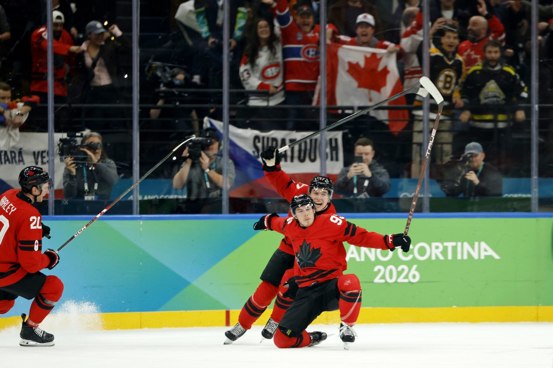 Mitch Marner of Canada celebrates with Thomas Harley after scoring their fourth and game-winning goal against Czechia in a men's ice hockey quarterfinal during the Milano Cortina 2026 Olympic Winter Games at Milano Santagiulia Ice Hockey Arena.