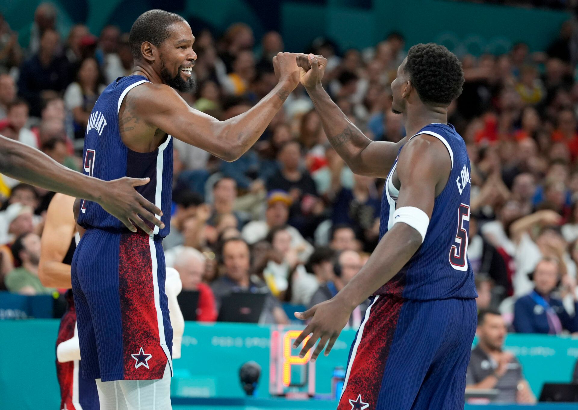 United States guard Kevin Durant (7) and guard Anthony Edwards (5) celebrate after a play  in the third quarter against Serbia during the Paris 2024 Olympic Summer Games at Stade Pierre-Mauroy.
