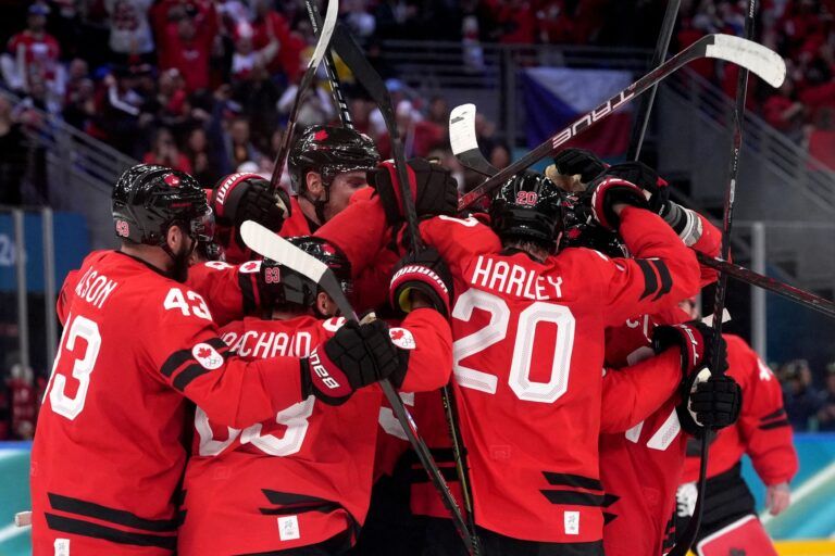 Mitch Marner of Canada celebrates with teammates after scoring their fourth goal in overtime to win the match against Czechia in a men's ice hockey quarterfinal during the Milano Cortina 2026 Olympic Winter Games at Milano Santagiulia Ice Hockey Arena.