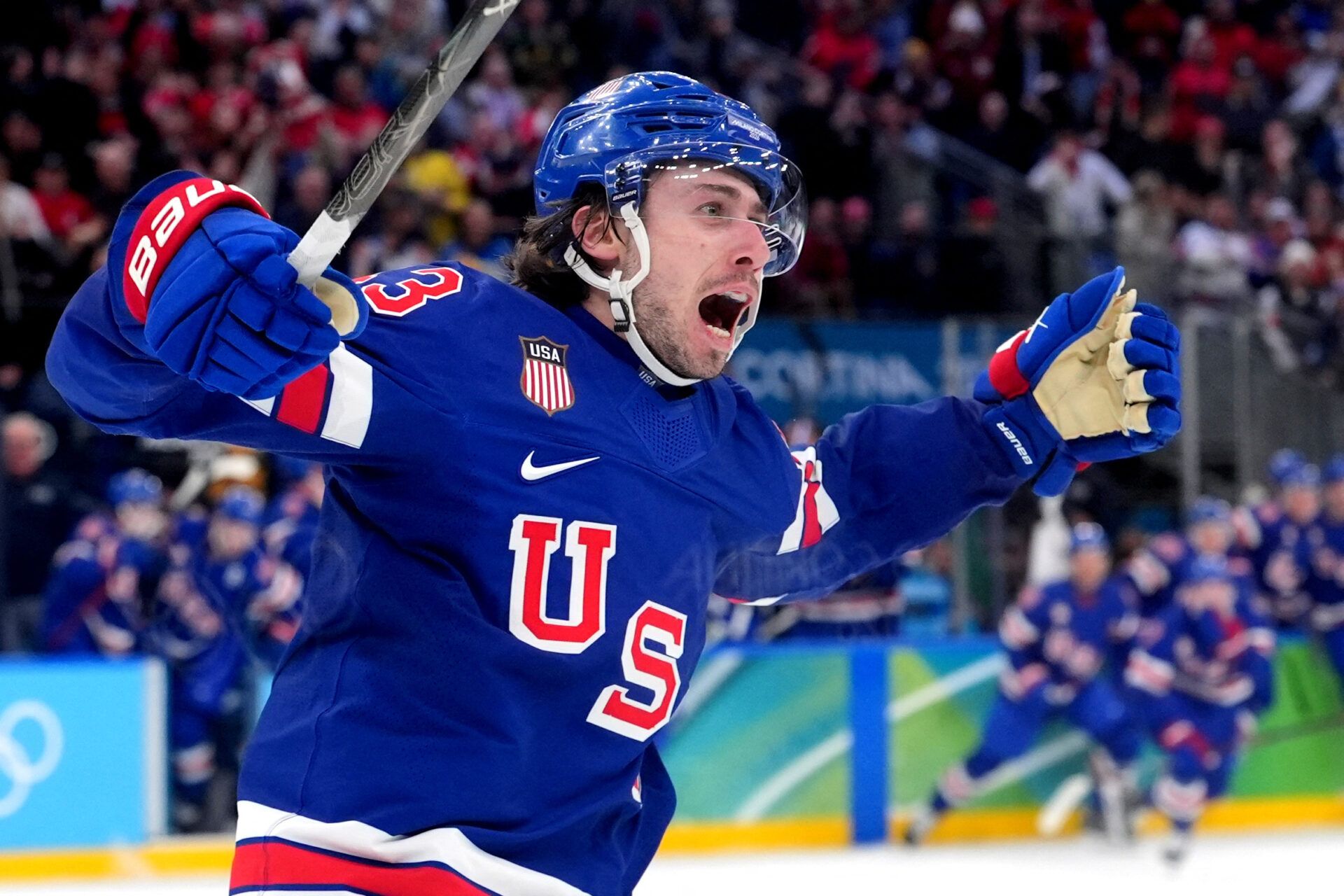 Quinn Hughes (43) of the United States celebrates his winning goal in overtime against Sweden in a men's ice hockey quarterfinal during the Milano Cortina 2026 Olympic Winter Games at Milano Santagiulia Ice Hockey Arena.