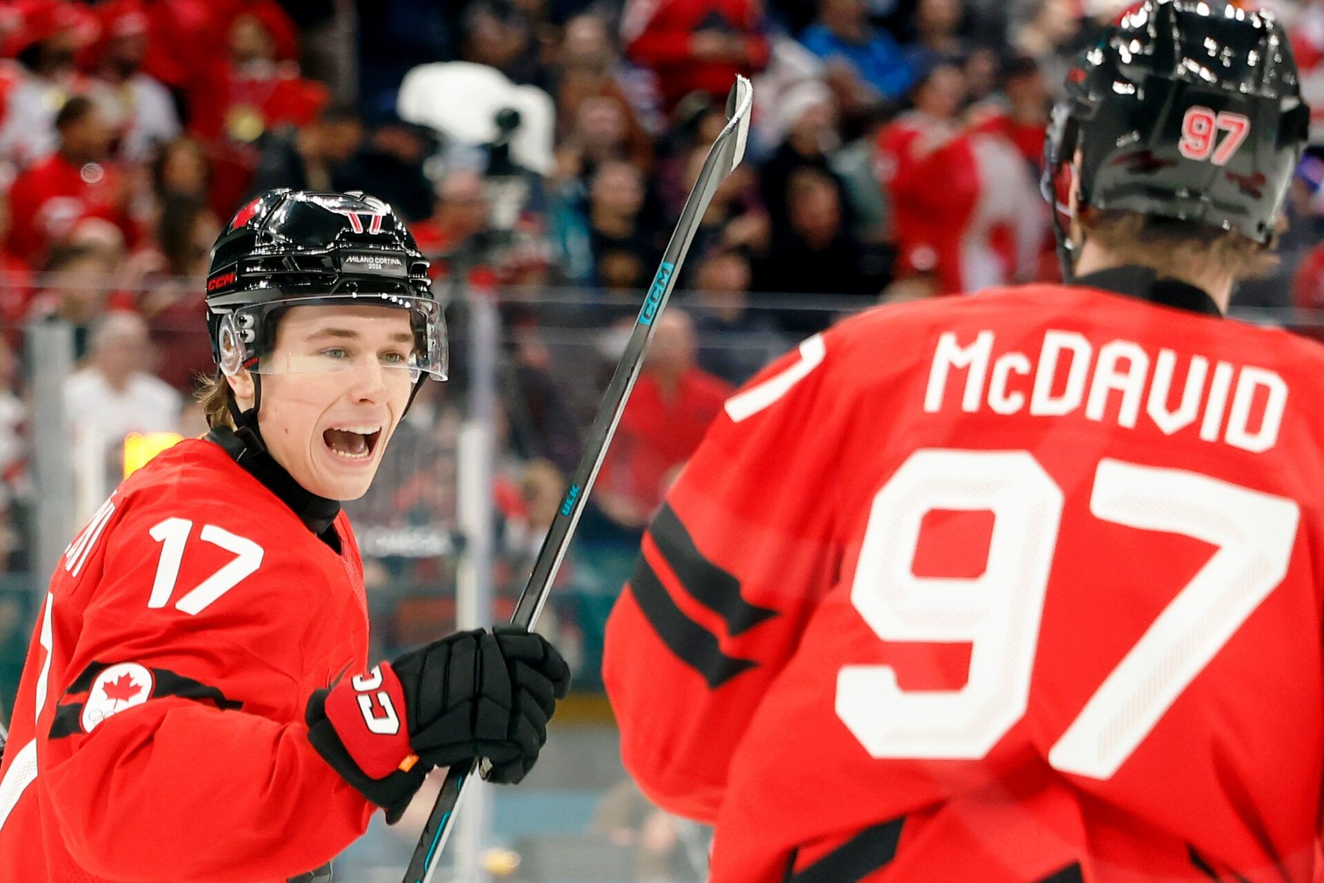 Macklin Celebrini of Canada celebrates with Connor McDavid after scoring their first goal against Czechia in a men's ice hockey quarterfinal during the Milano Cortina 2026 Olympic Winter Games at Milano Santagiulia Ice Hockey Arena.