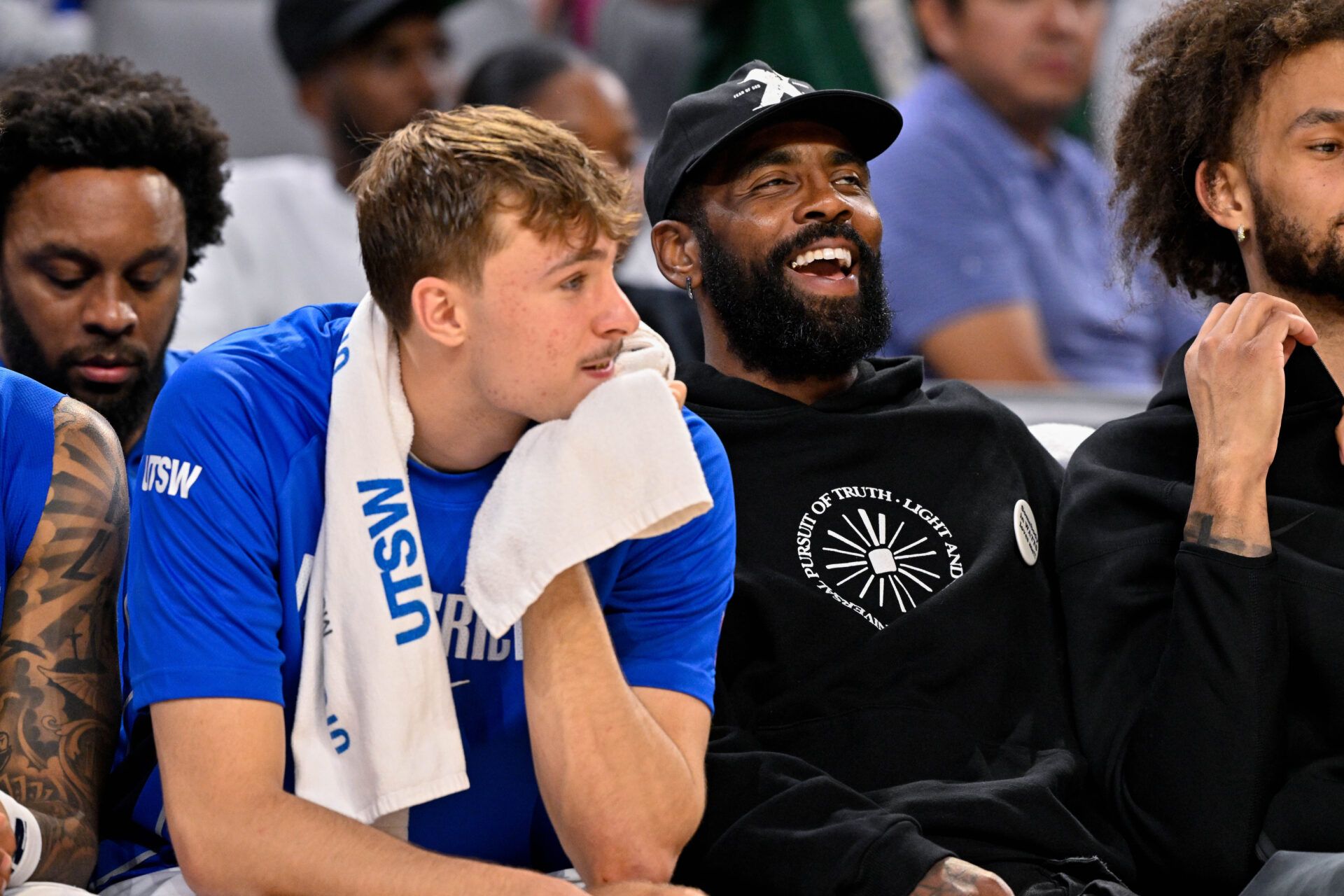 Dallas Mavericks forward Cooper Flagg (left) and guard Kyrie Irving (right) look on during the game between the Dallas Mavericks and the Oklahoma City Thunder at Dickie's Arena.