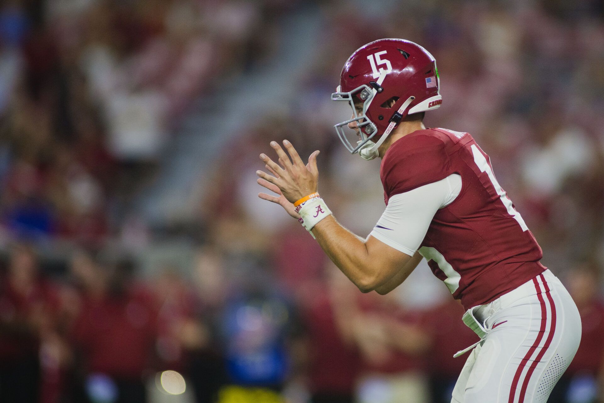 Alabama Crimson Tide quarterback Ty Simpson (15) reaches out for a snap during the fourth quarter at Bryant-Denny Stadium.