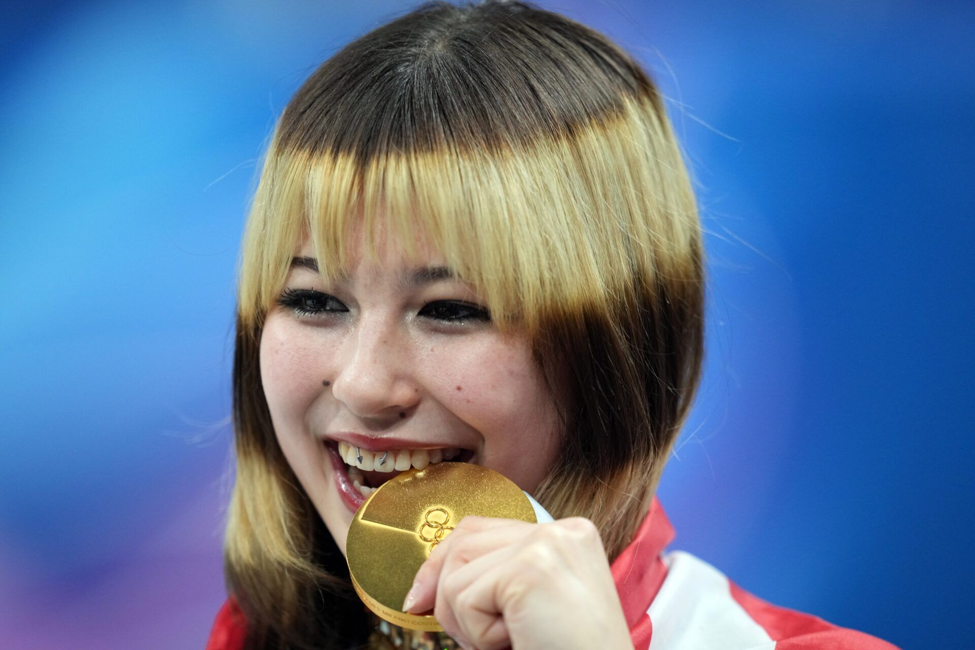 Alysa Liu of the United States celebrates with the gold medal in the women's free skate during the Milano Cortina 2026 Olympic Winter Games at Milano Ice Skating Arena.