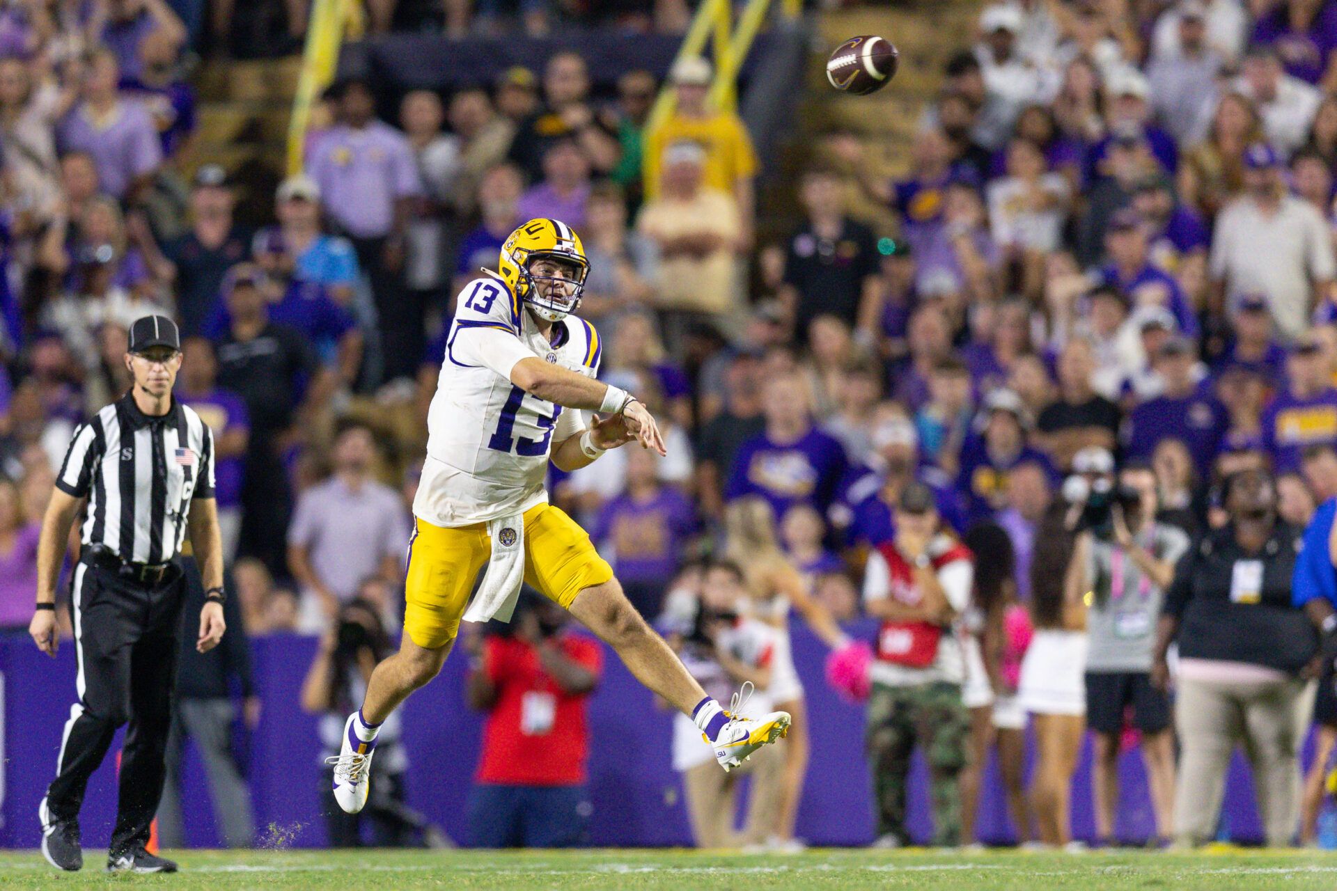 LSU Tigers quarterback Garrett Nussmeier (13) throws for a first down against the Mississippi Rebels during the second half at Tiger Stadium.