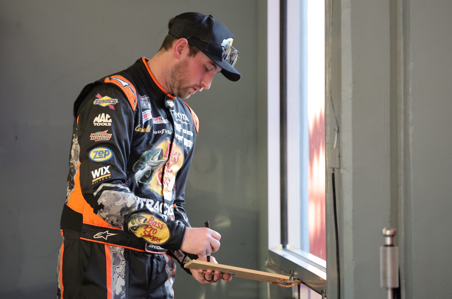 NASCAR Cup Series driver Chase Briscoe (19) signs autographs during NASCAR Cup Series practice at Daytona International Speedway.