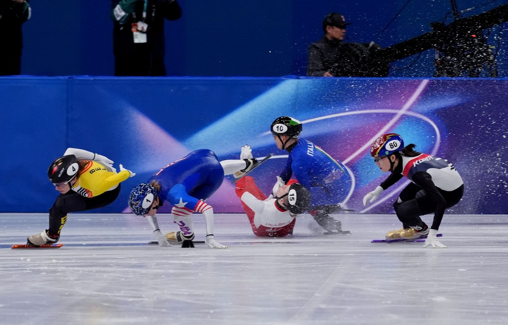 Kristen Santos-Griswold of the United States, Kamila Sellier of Poland and Arianna Fontana of Italy fall in the women's short track speed skating 1500m quarterfinals during the Milano Cortina 2026 Olympic Winter Games at Milano Ice Skating Arena.