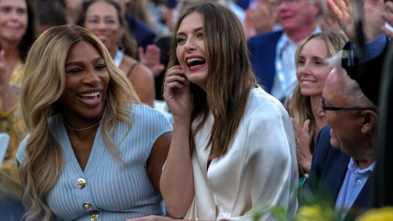 Tennis legend Serena Williams, left, makes a surprise appearance to induct Maria Sharapova into the International Tennis Hall of Fame on Aug. 23.