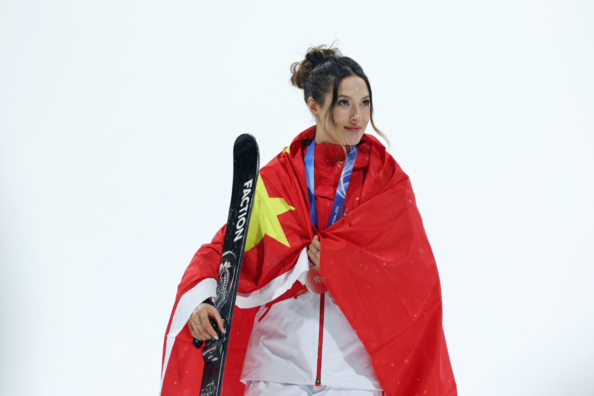 Silver medalist Ailing Eileen Gu of the People's Republic of China looks on during the medal ceremony for the women's big air final during the Milano Cortina 2026 Olympic Winter Games at Livigno Snow Park.