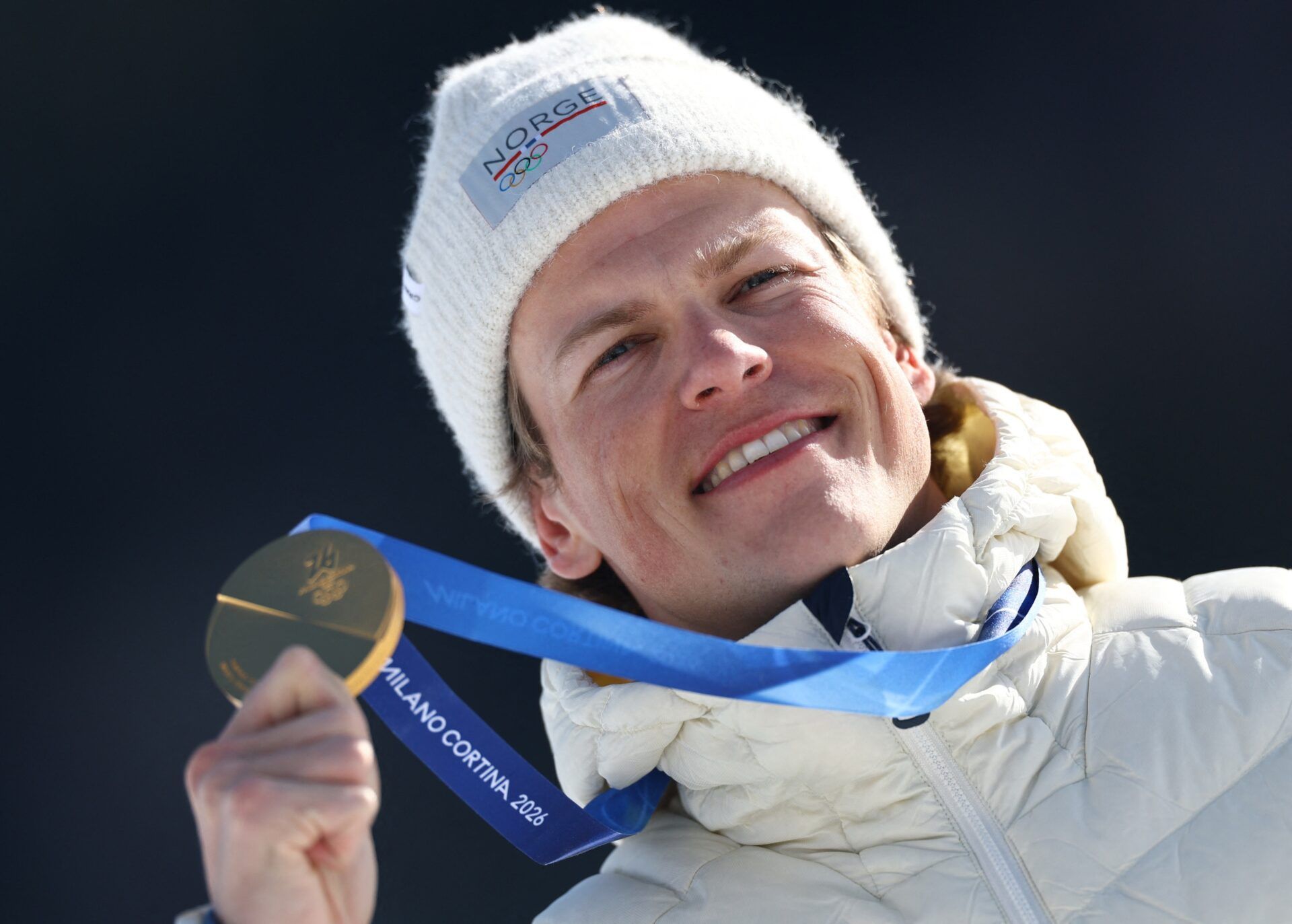 [US, Mexico & Canada customers only] Feb 8, 2026; Tesero, Italy; Gold medallist Johannes Hoesflot Klaebo of Norway celebrates on the podium after winning the Men's 10km + 10km Skiathlon during the Milano Cortina 2026 Olympic Winter Games at Tesero Cross-Country Skiing Stadium.
