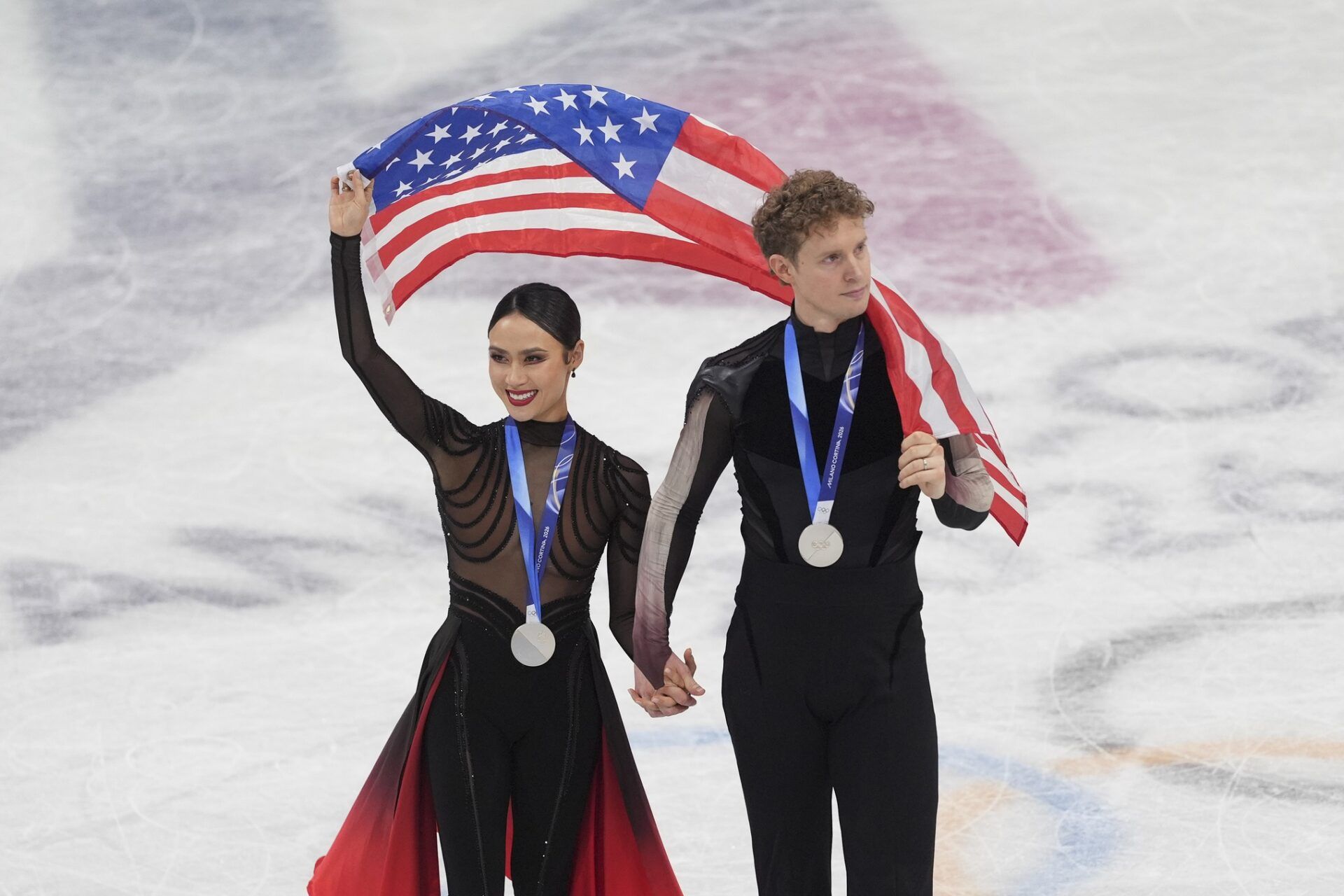 Madison Chock and Evan Bates of the United States of America skate after receiving their medals during the Milano Cortina 2026 Olympic Winter Games at Milano Ice Skating Arena.