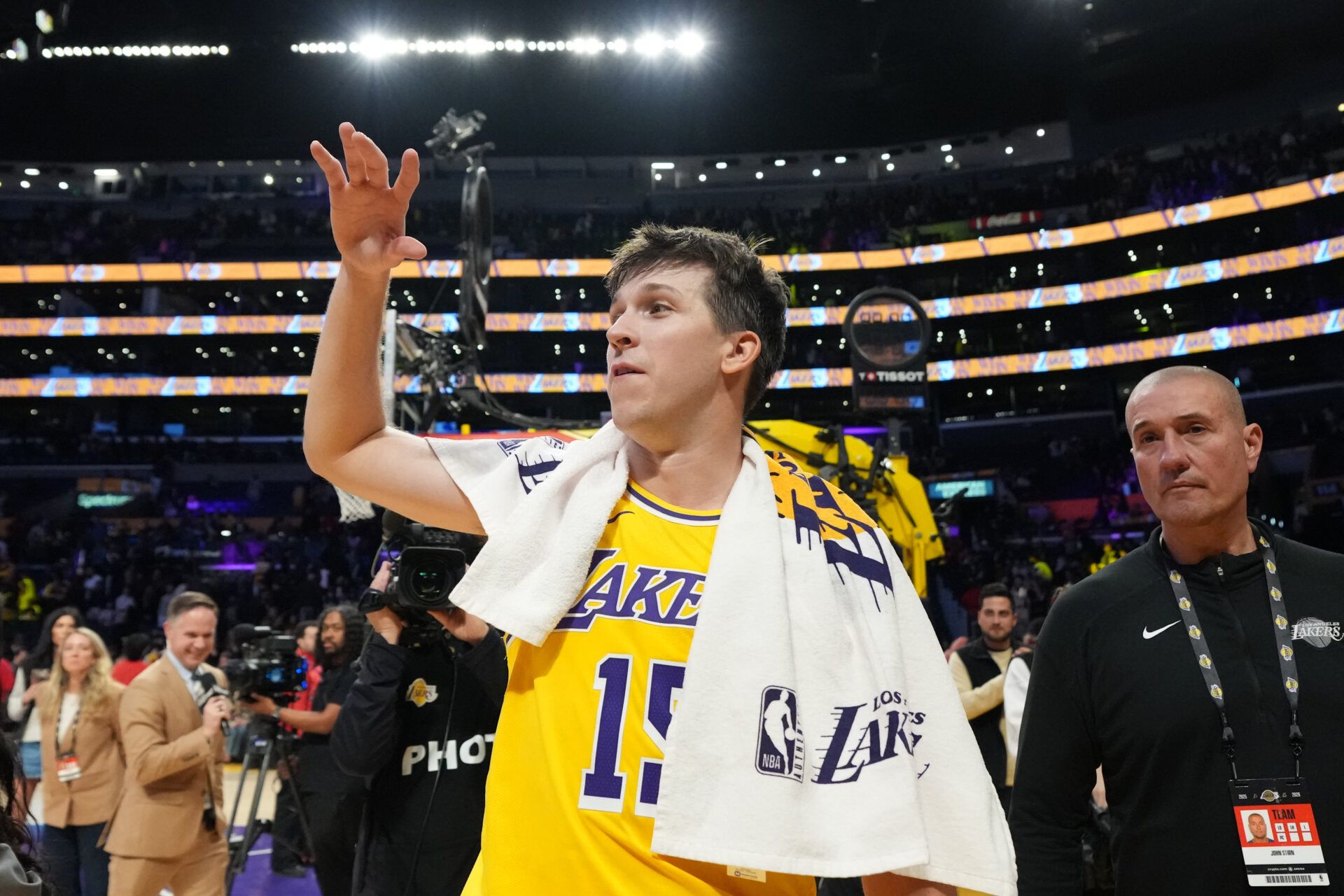 Los Angeles Lakers guard Austin Reaves (15) is escorted by John Stirn after the game against the LA Clippers at Crypto.com Arena.