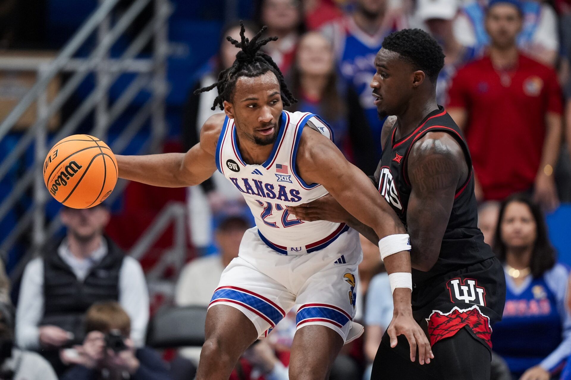 Kansas Jayhawks guard Darryn Peterson (22) drives against Utah Utes forward Seydou Traore (0) during the first half at Allen Fieldhouse.