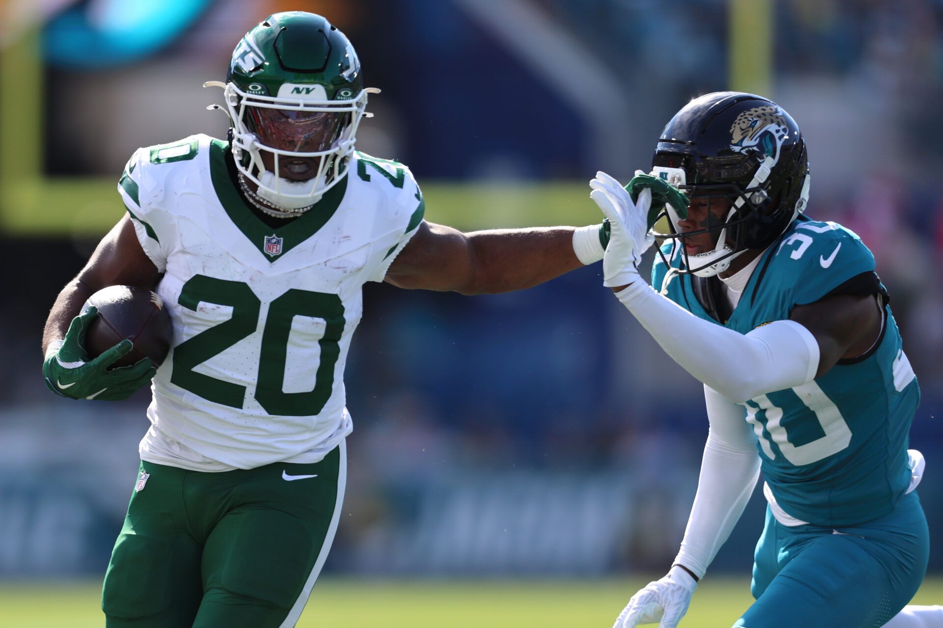 New York Jets running back Breece Hall (20) runs with the ball against Jacksonville Jaguars cornerback Montaric Brown (30) during the first quarter at EverBank Stadium.
