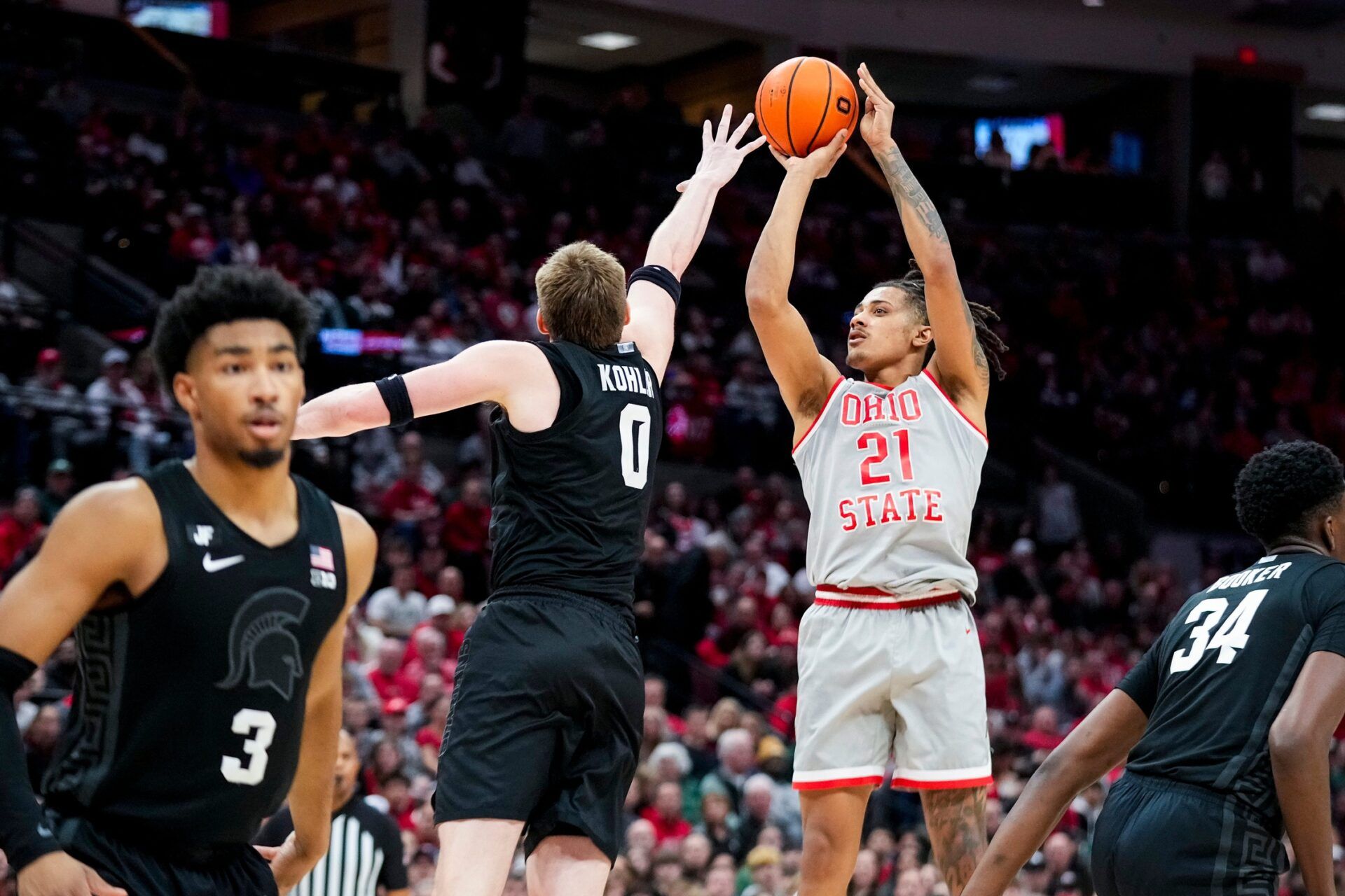 Ohio State Buckeyes forward Devin Royal (21) shoots the ball against Michigan State Spartans forward Jaxon Kohler (0) in the second half at Value City Arena on Friday, Jan. 3, 2025 in Columbus, Ohio. © Samantha Madar/Columbus Dispatch / USA TODAY NETWORK via Imagn Images