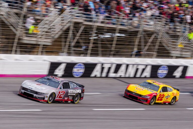 Ryan Blaney (12) and Joey Logano (22) come through turn four at Atlanta Motor Speedway.