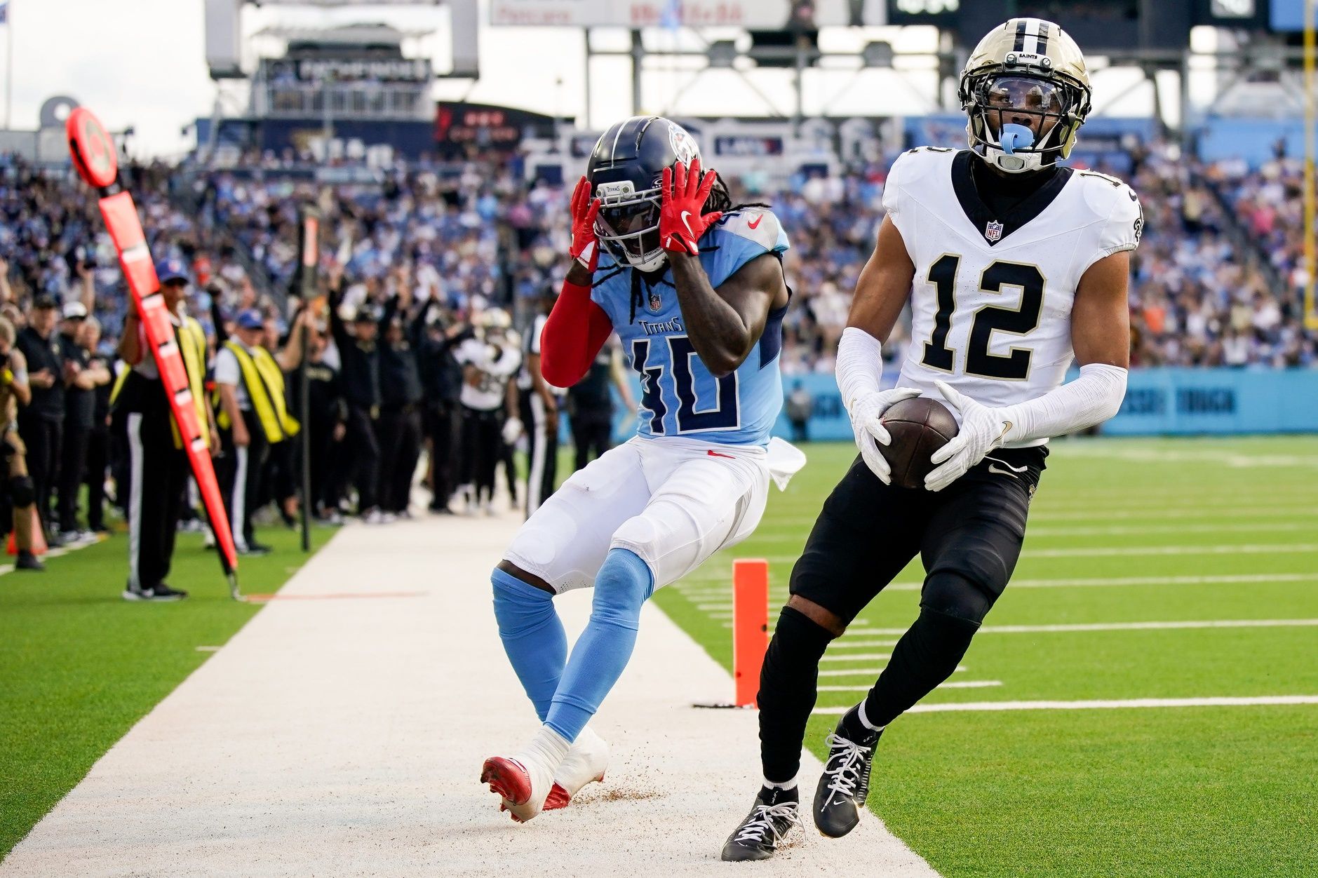Tennessee Titans cornerback Kemon Hall (40) reacts as New Orleans Saints wide receiver Chris Olave (12) brings in a touchdown during the third quarter at Nissan Stadium in Nashville, Tenn., Sunday, Dec. 28, 2025.