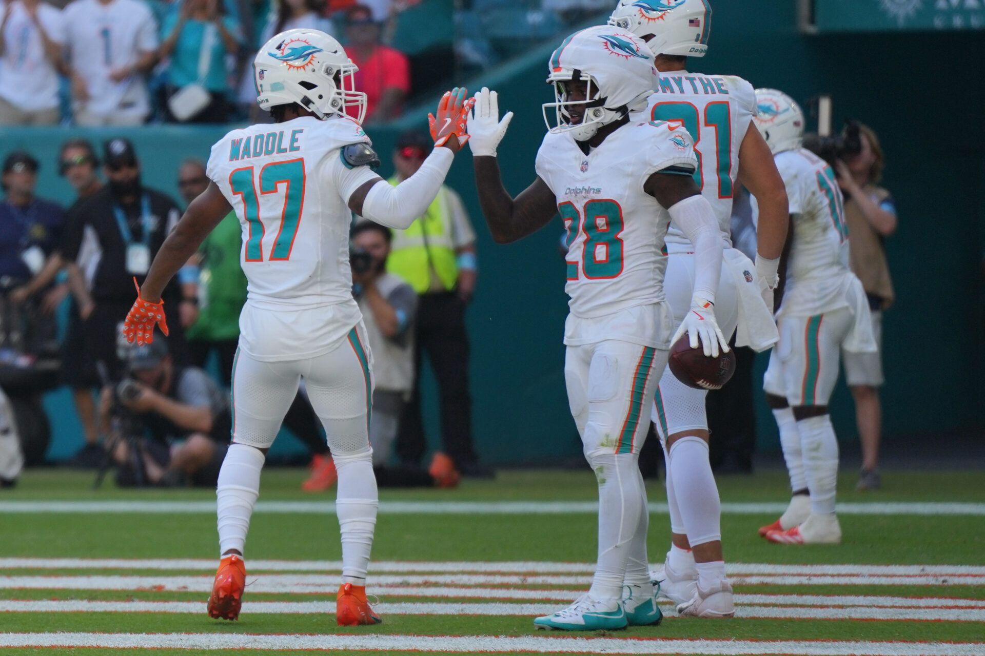 Miami Dolphins running back De'Von Achane (28) celebrates a touchdown against the Arizona Cardinals with teammate Jaylen Waddle (17) in the third quarter at Hard Rock Stadium.