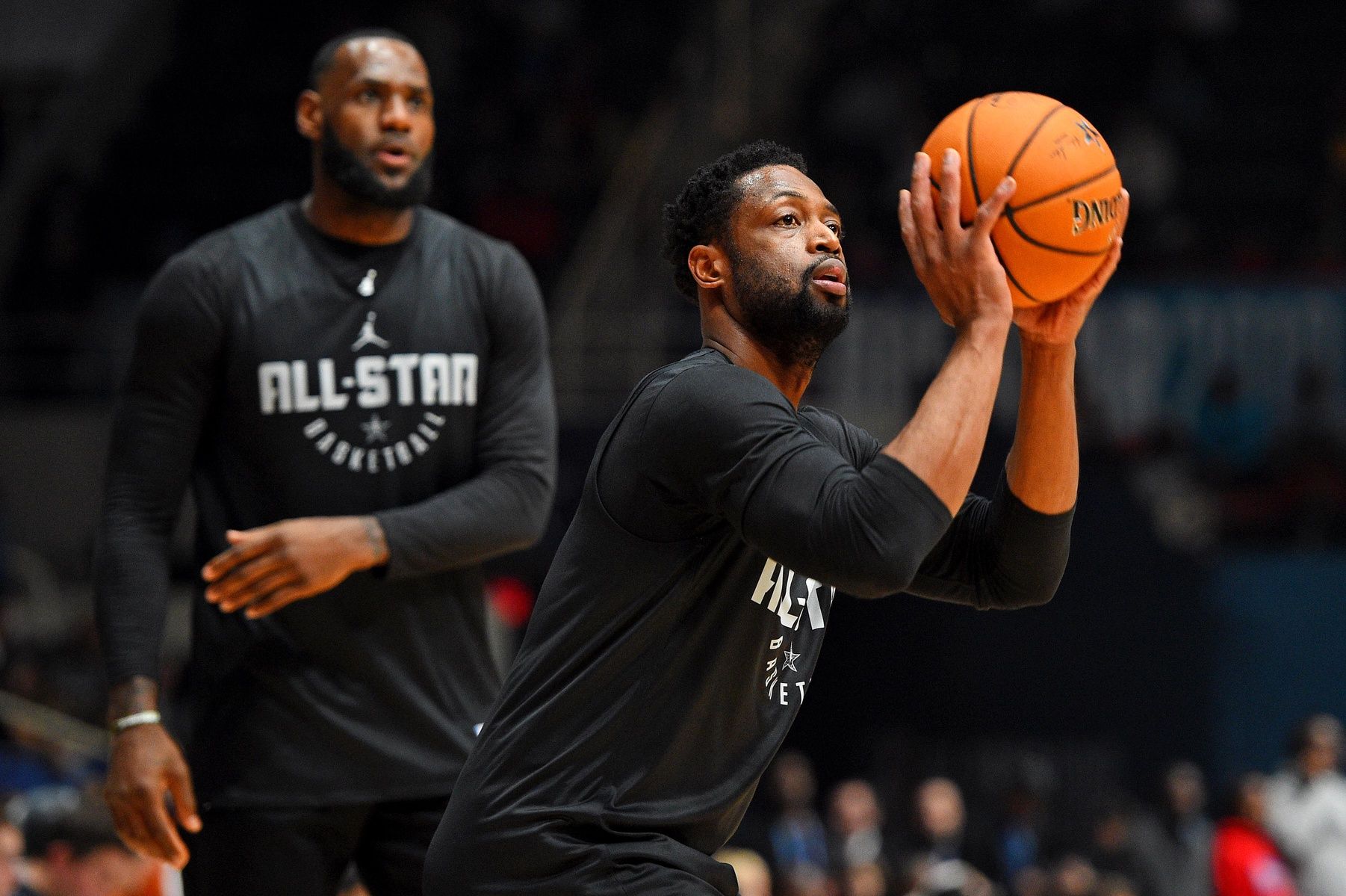 Team Lebron guard Dwayne Wade of the Miami Heat (3) shoots the ball as Team Lebron forward Lebron James of the Los Angeles Lakers (23) watches during NBA All-Star Game practice at the Bojangles Coliseum.