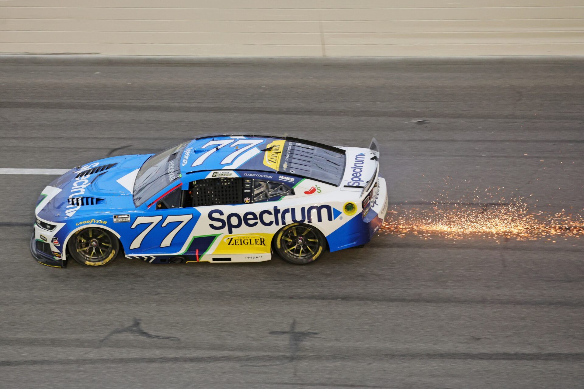 Driver Carson Hocevar (77) shows sparks during the 68th running of the Daytona 500 at Daytona International Speedway.