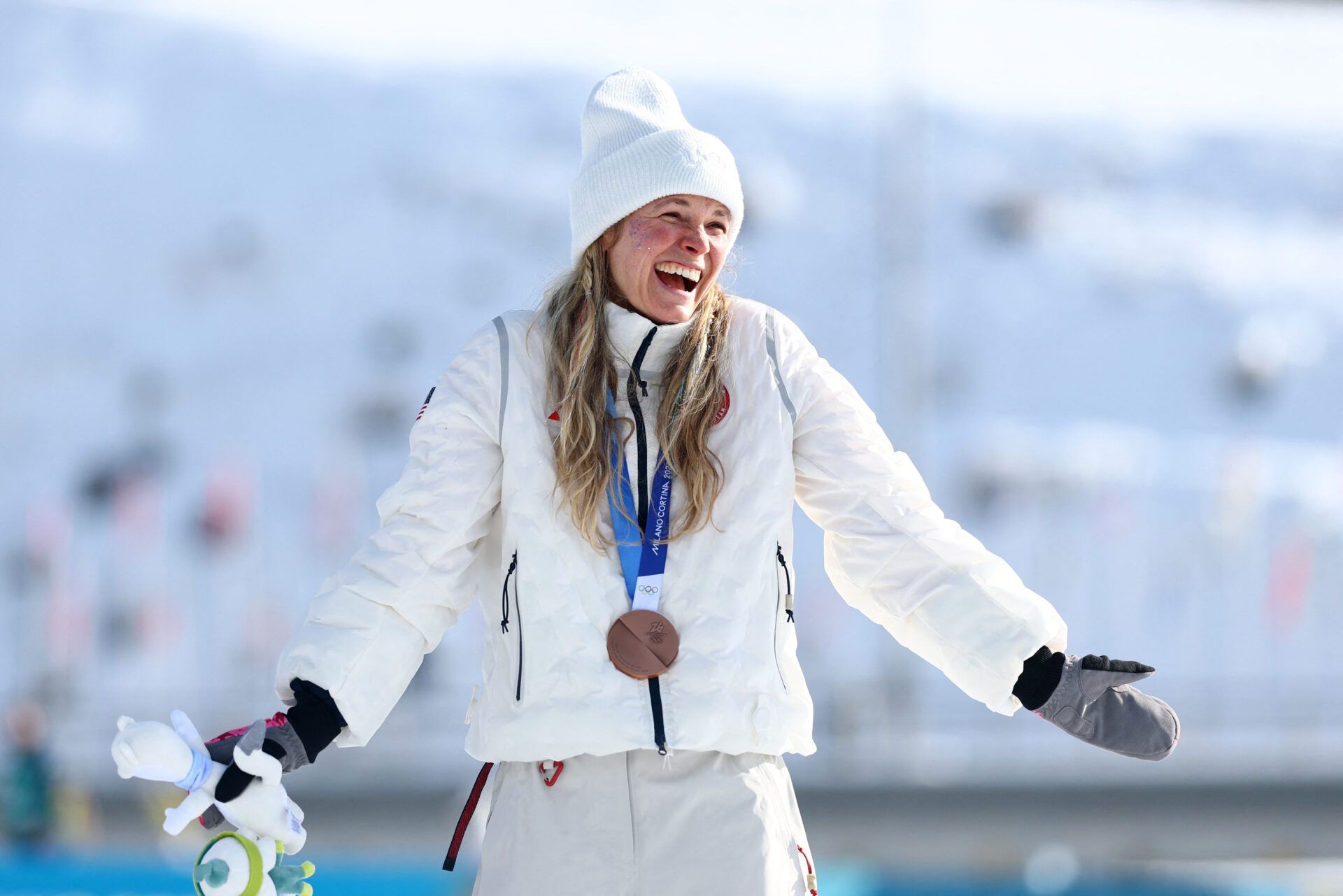 [US, Mexico & Canada customers only] Feb 12, 2026; Tesero, Italy; Bronze medallist Jessie Diggins of the United States celebrates on the podium in the women's cross country skiing 10km interval start freestyle during the Milano Cortina 2026 Olympic Winter Games at Tesero Cross-Country Skiing Stadium.
